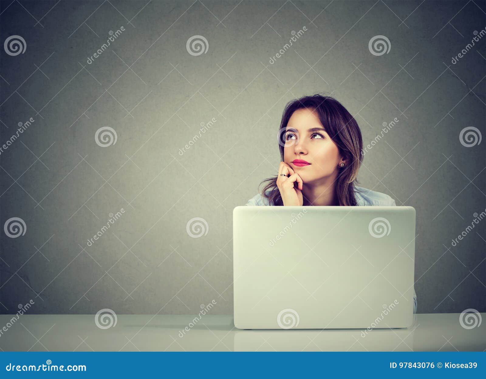 business woman thinking daydreaming sitting at desk with laptop computer