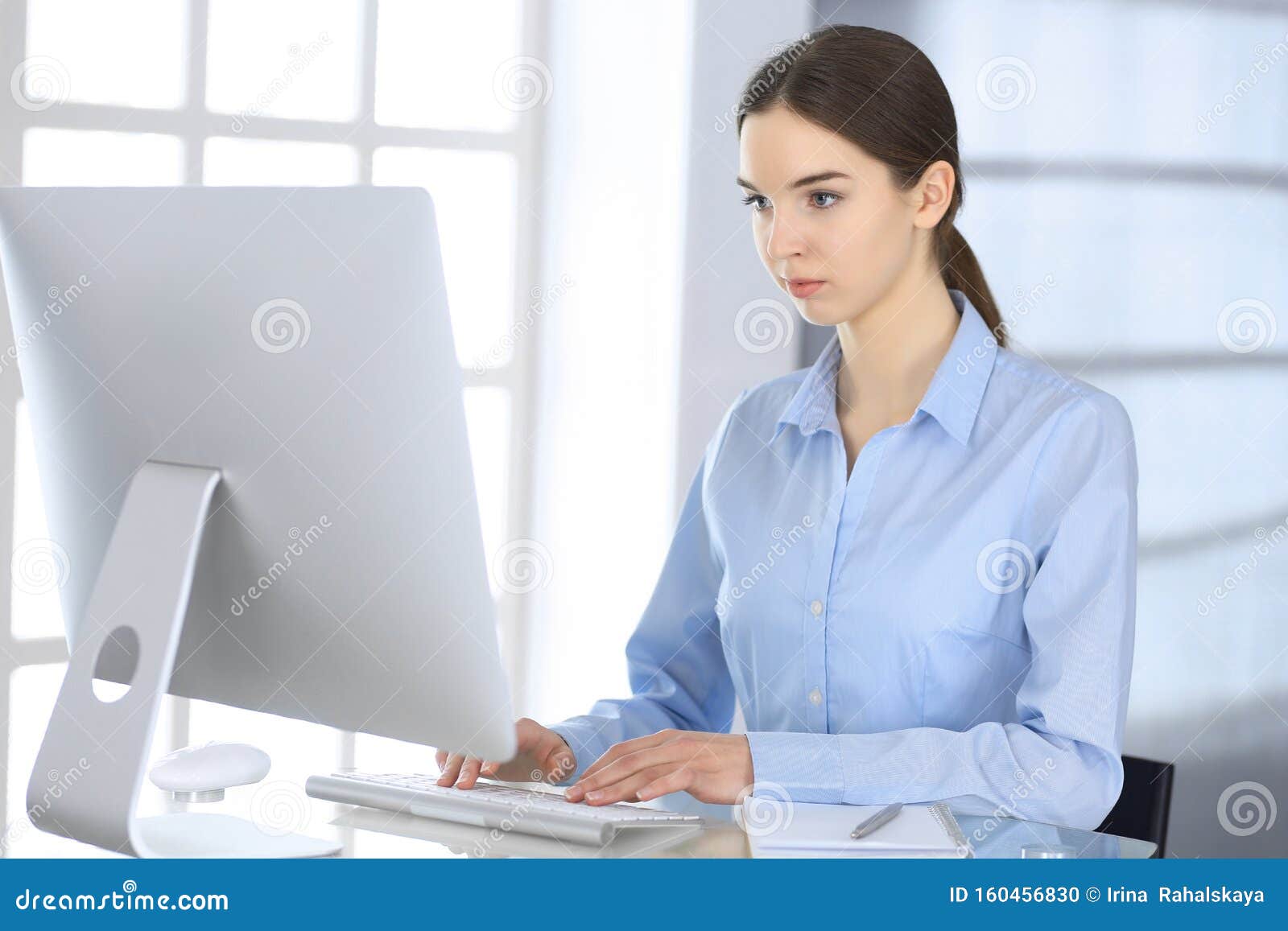 Business Woman Working With Computer At The Glass Desk In Modern