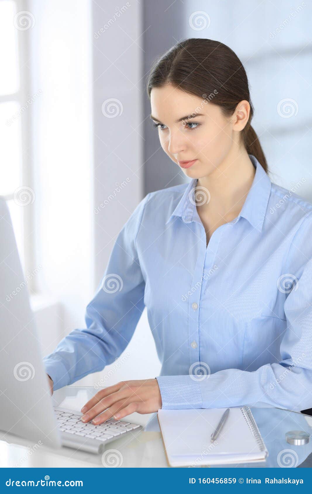 Business Woman Working With Computer At The Glass Desk In Modern