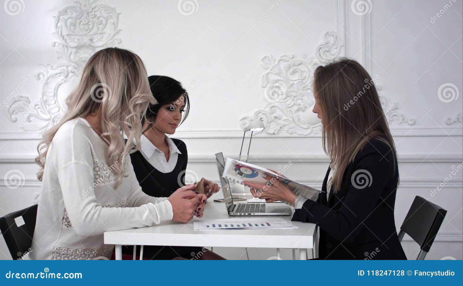 business women working at meeting ,one of busines woman showing on a diagram
