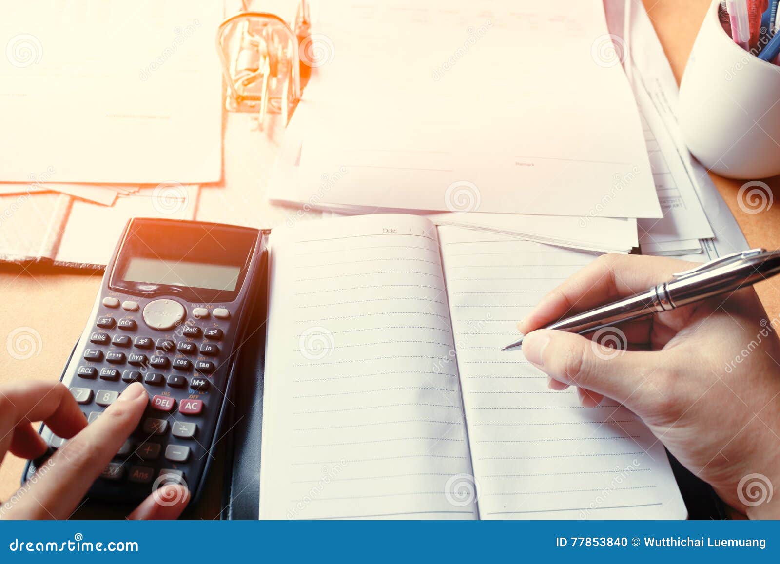 Business Young Man Writing Make Note Report and Counting Calculator at