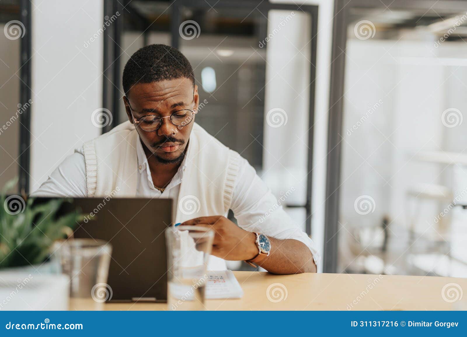 businessman alone in office, researching market, optimizing strategies. multiracial company, networking, profit-driven.