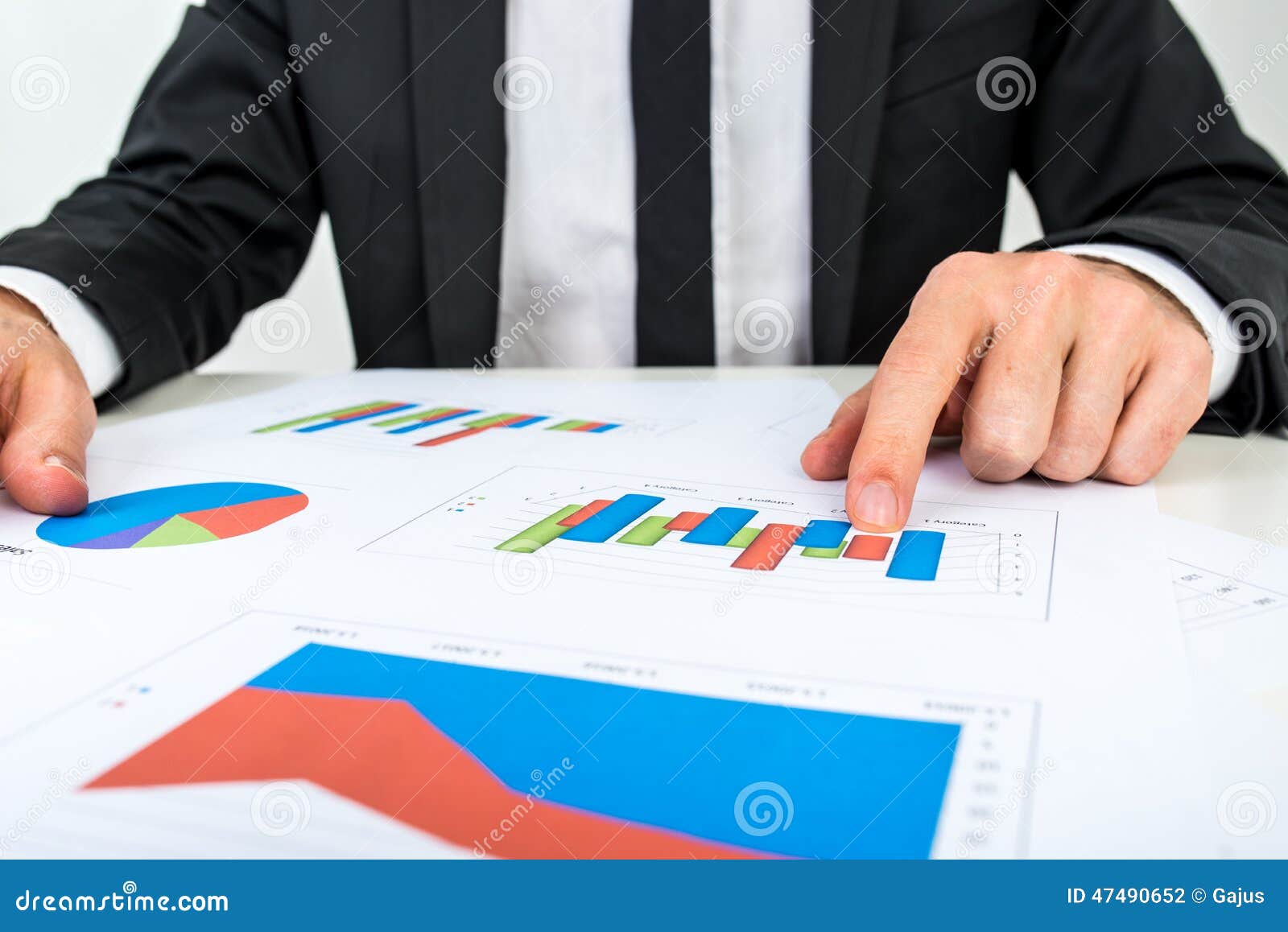 businessman analysing a set of bar graphs