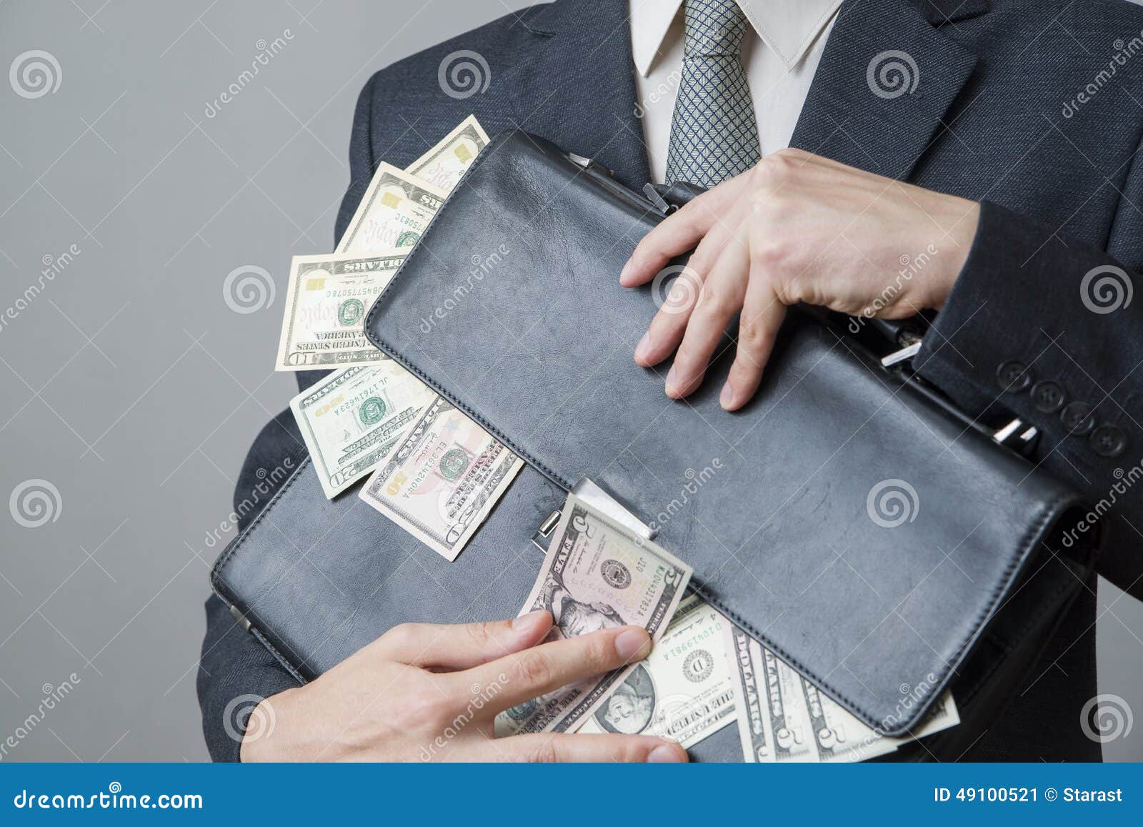 Businessman with a Briefcase Full of Money in the Hands of Stock Image