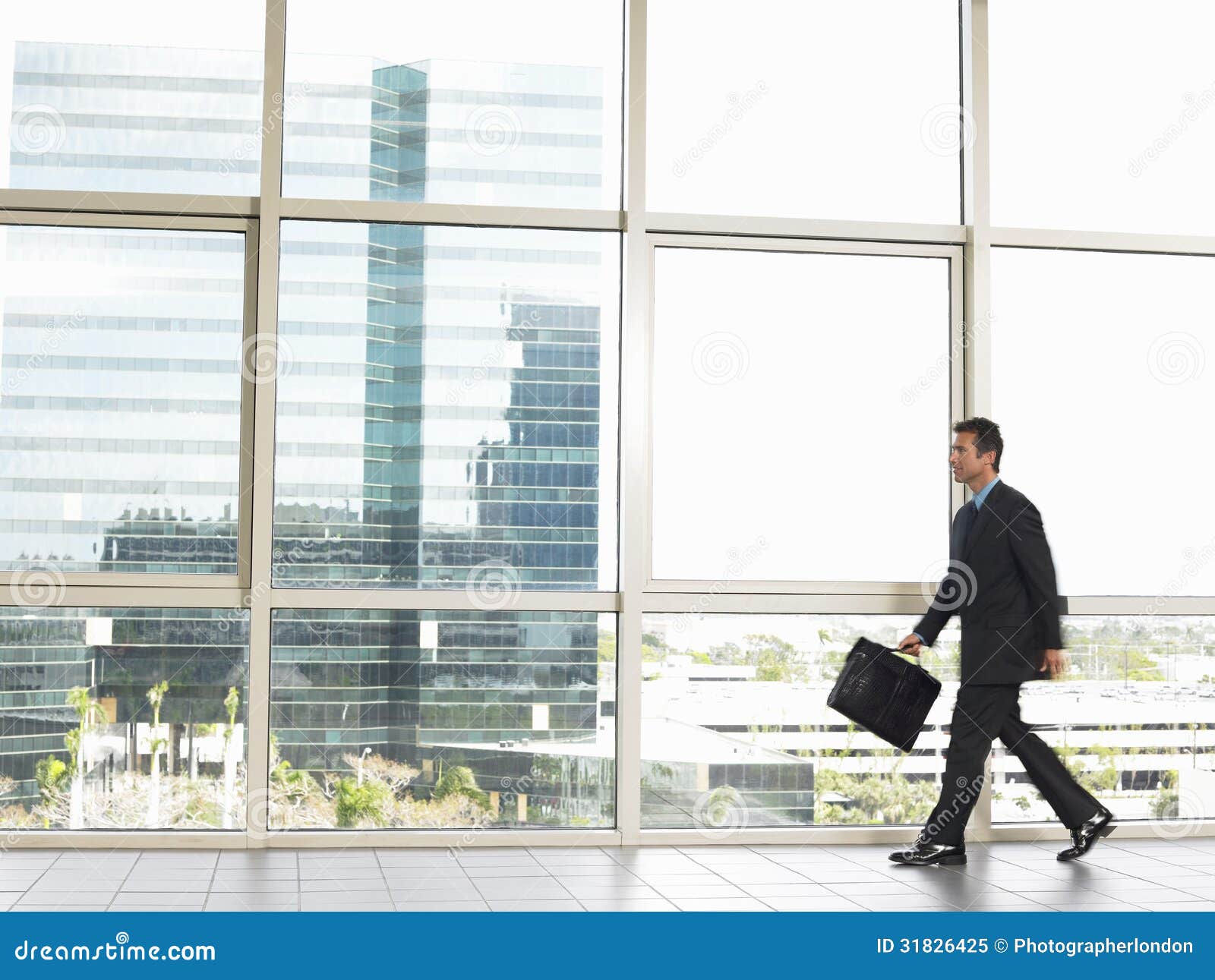 Businessman with Briefcase Walking in Office Stock Image Image of