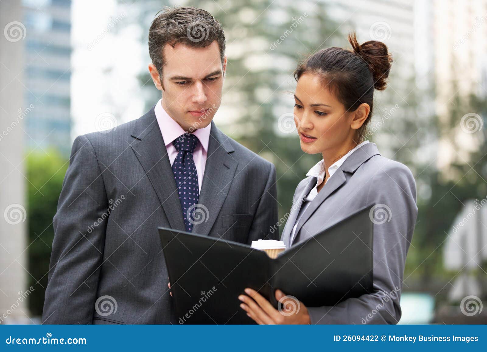 Businessman and Businesswoman Discussing Document Stock Photo Image