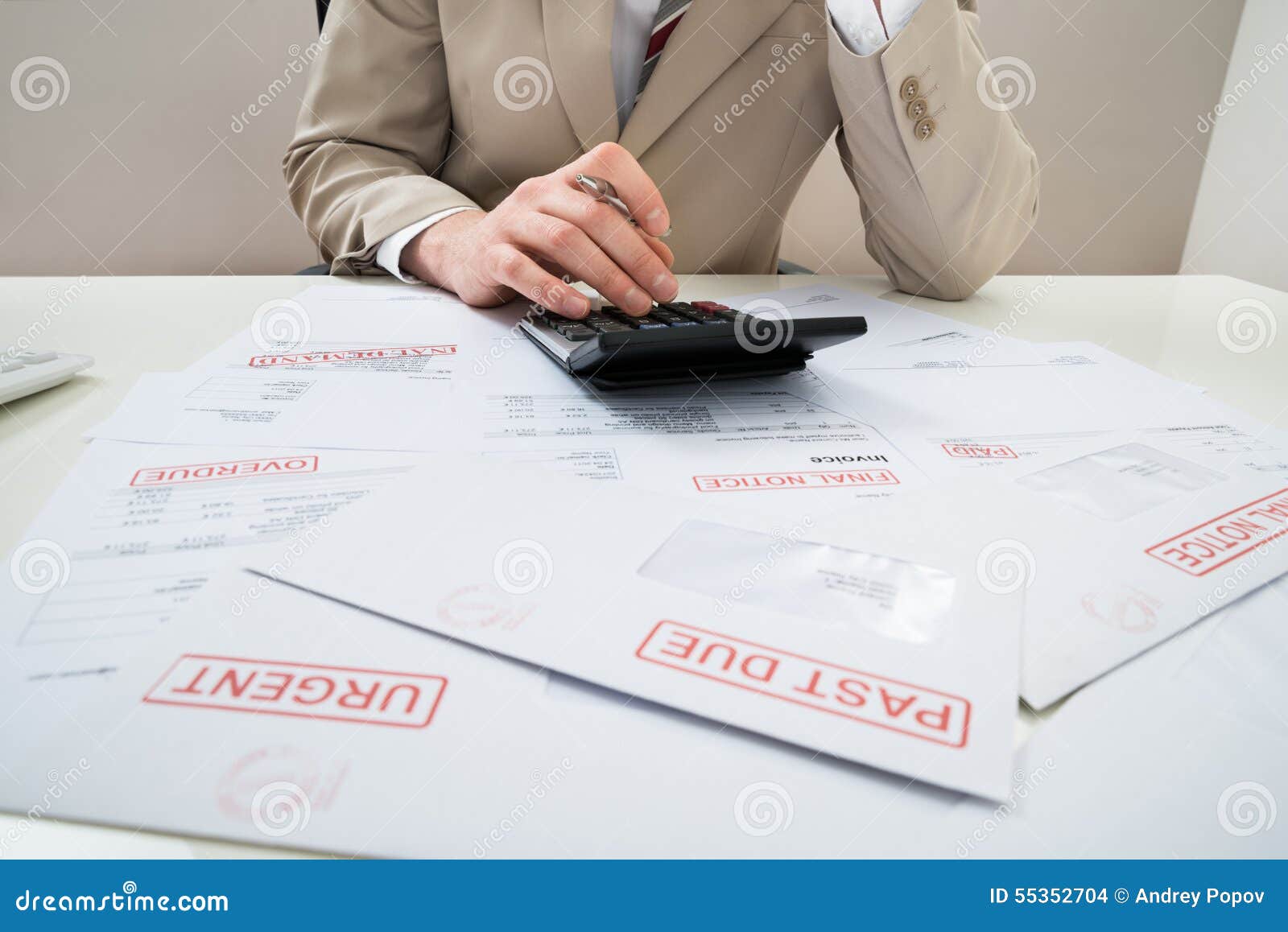 businessman with calculator and unpaid bills