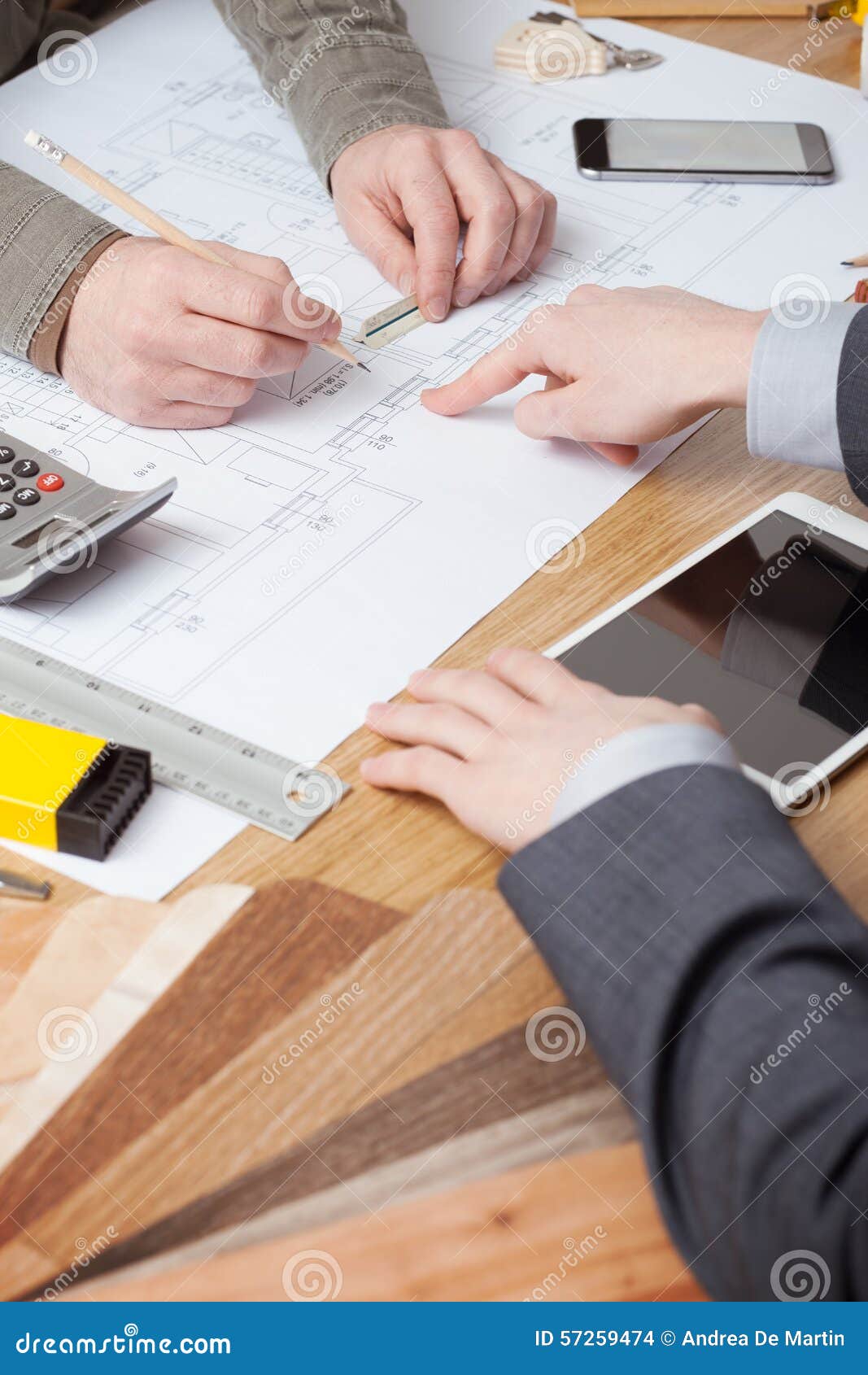 Businessman and construction engineer working together. Customer businessman and architect working together, one is pointing on a blueprint on the desk