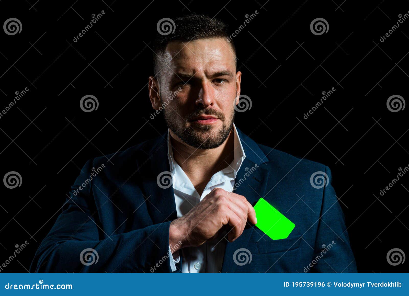 businessman with a credit card. business man in black suit put or take out creditcard in pocket, close up.
