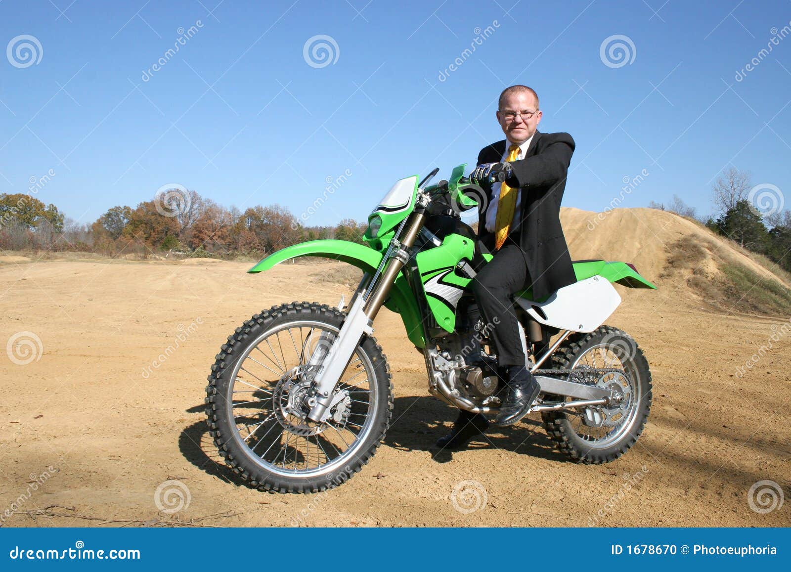 Businessman on Dirt Bike stock photo. Image of person 1678670