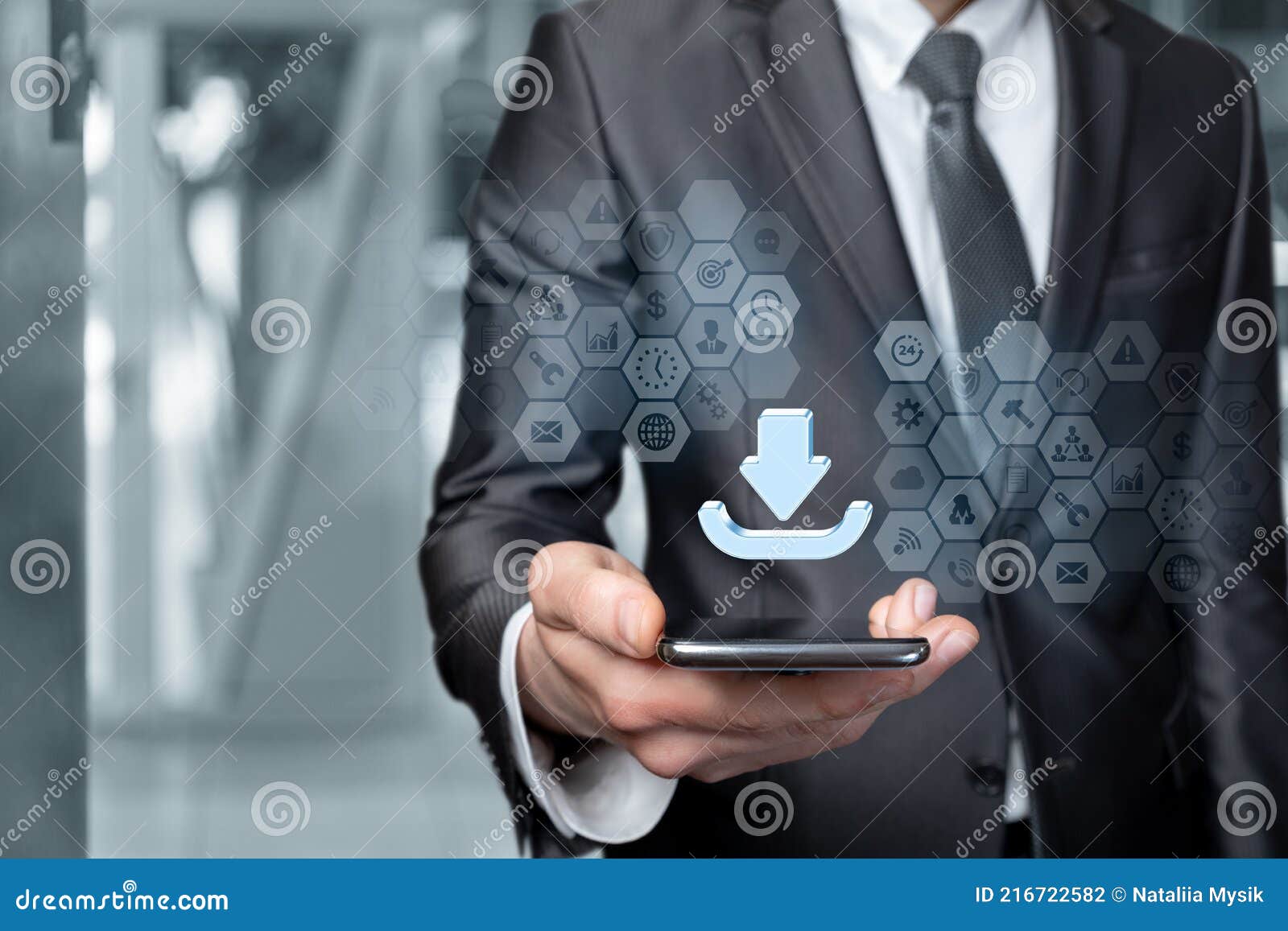 businessman downloads information to a mobile device on a blurred background