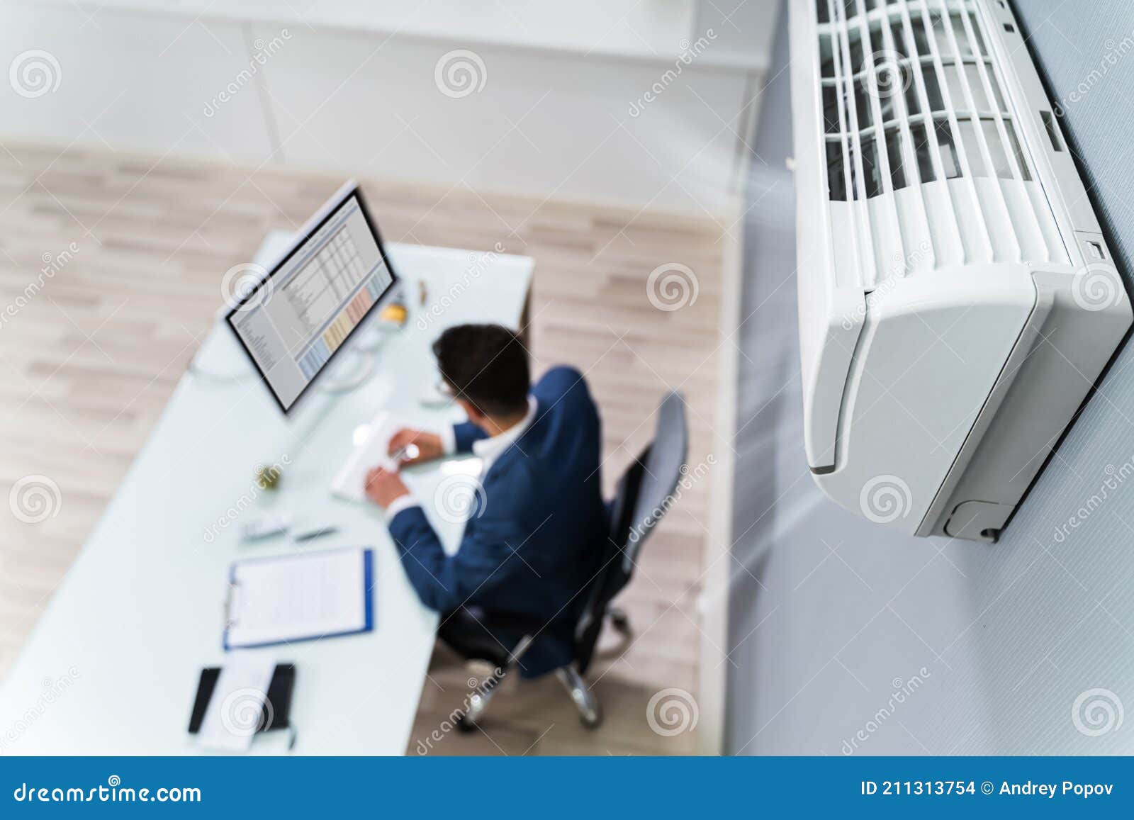 businessman enjoying the cooling of air conditioner