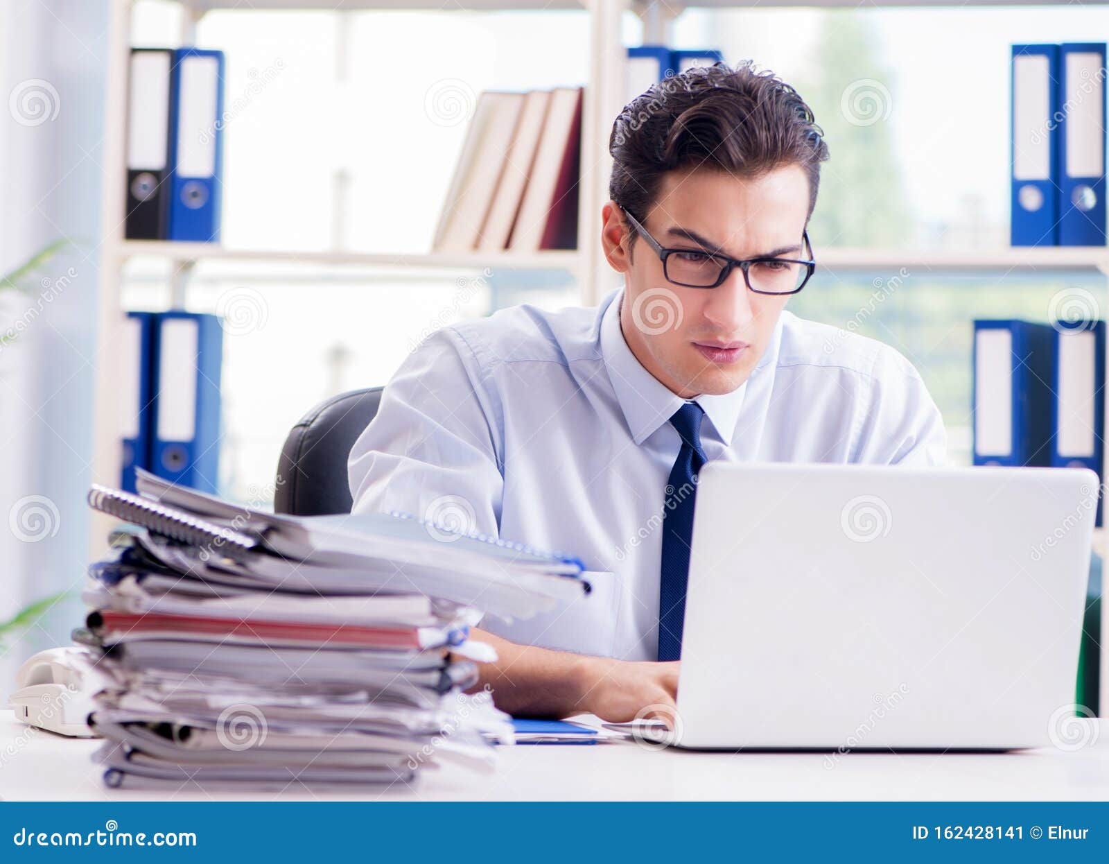 Businessman with Excessive Work Paperwork Working in Office Stock Image