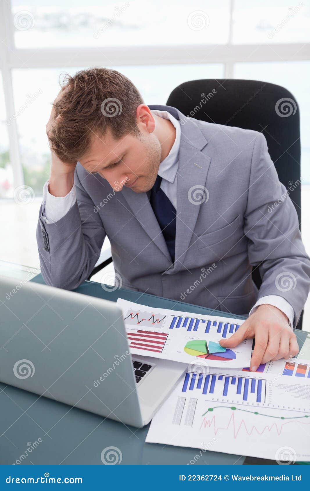 Businessman Frustrated By Market Research Results Stock Photo