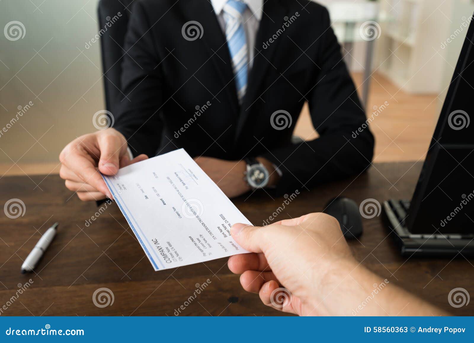 businessman giving cheque to other person
