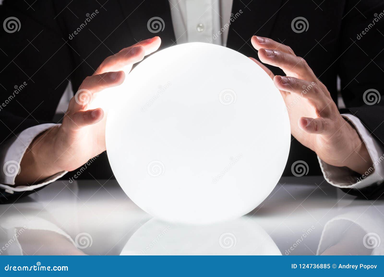 businessman hand on crystal ball