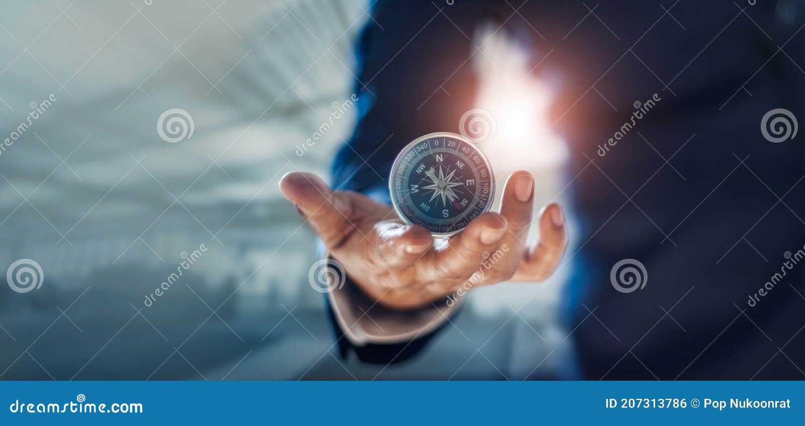 businessman hand holding compass navigating business direction and successful strategic solution