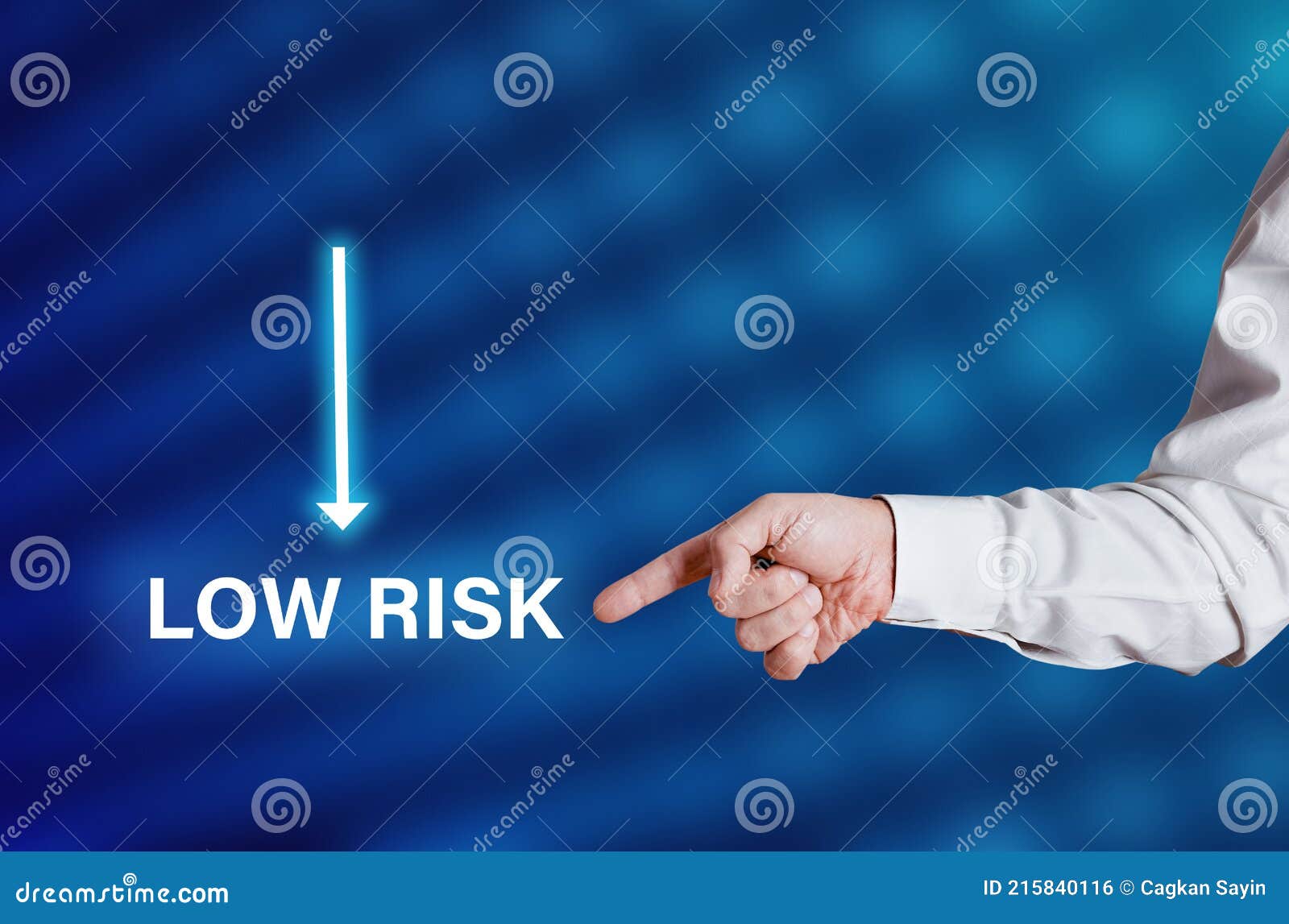 Businessman Hand Points To the Word Low Risk with Arrow Icon Stock