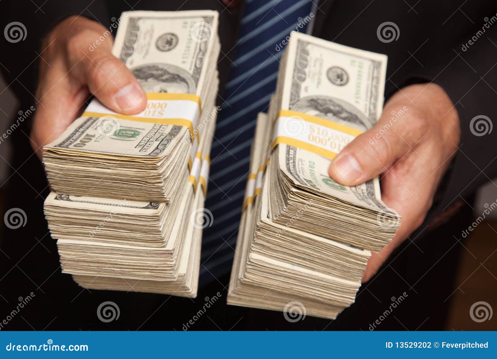 businessman handing over stacks of money