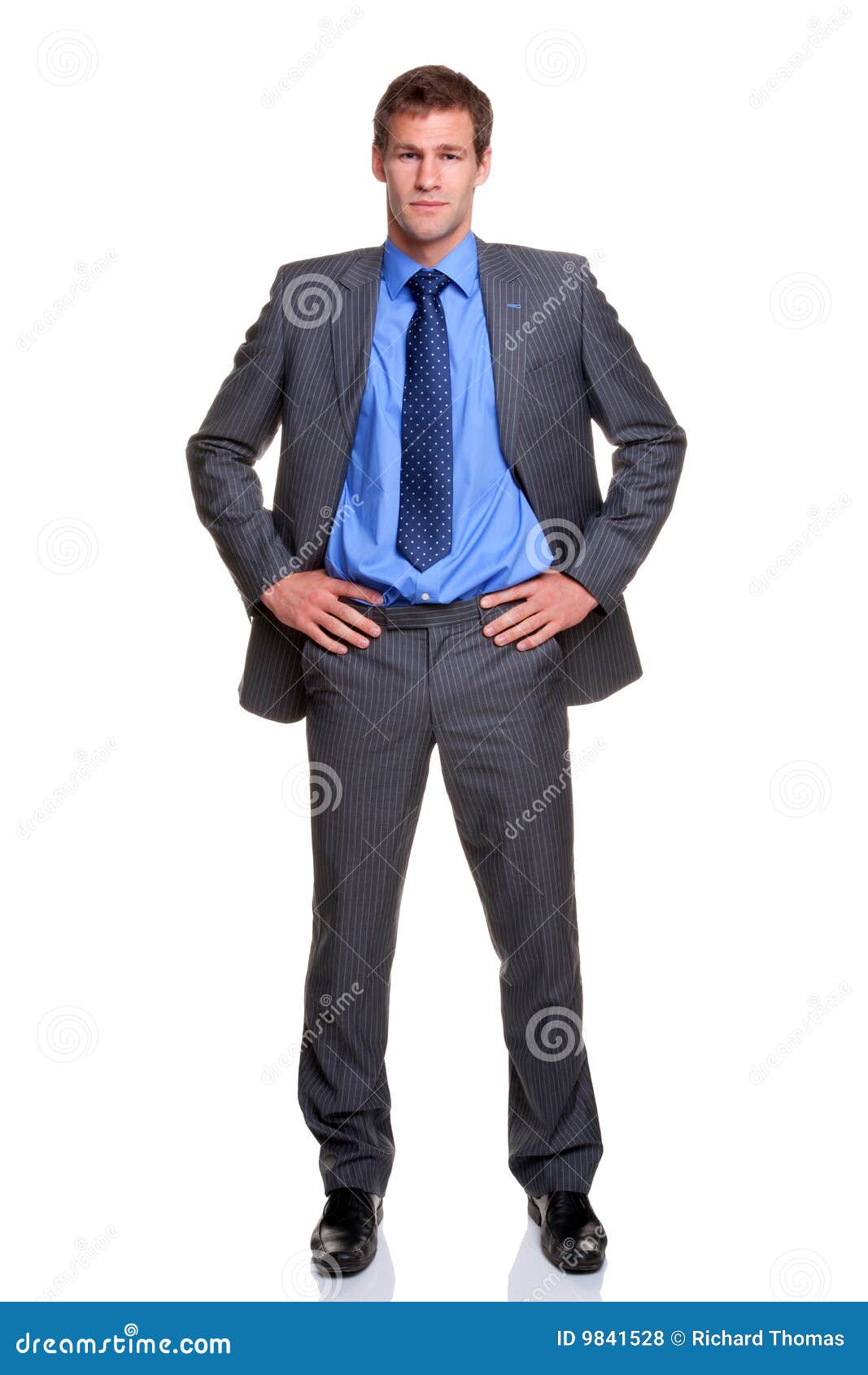 businessman hands on hips 
