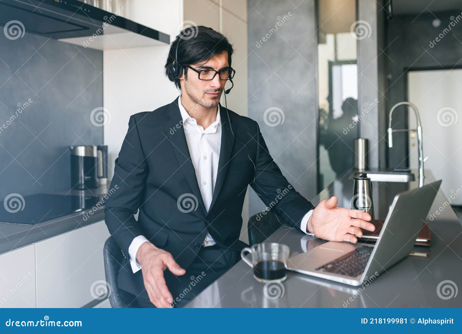 businessman with headset at a video conference from his home computer