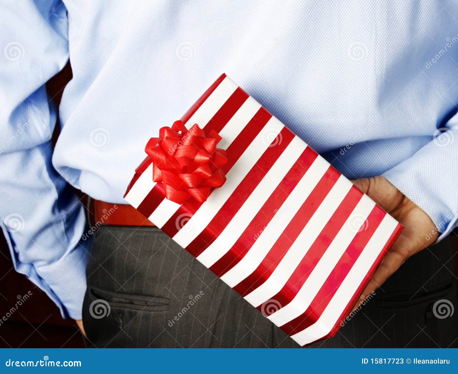 Businessman hiding a gift stock image. Image of nice 15817723
