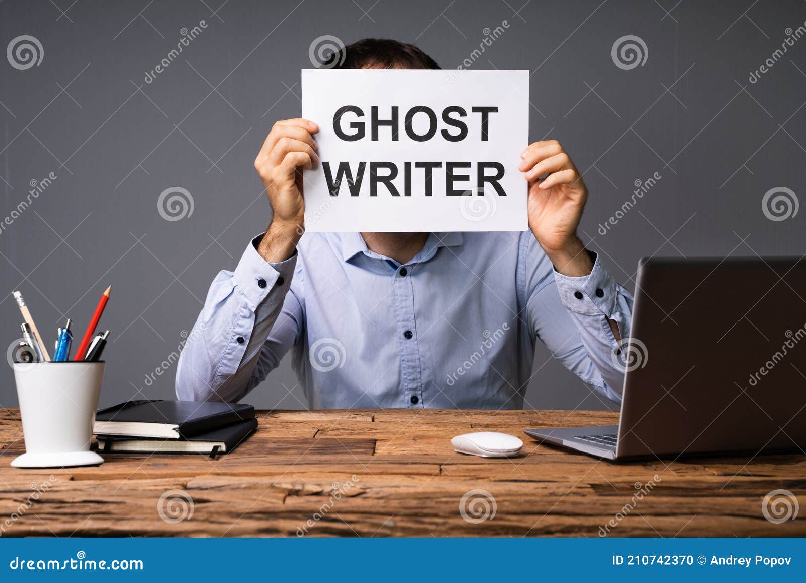businessman hiding his face behind card with ghost writer text