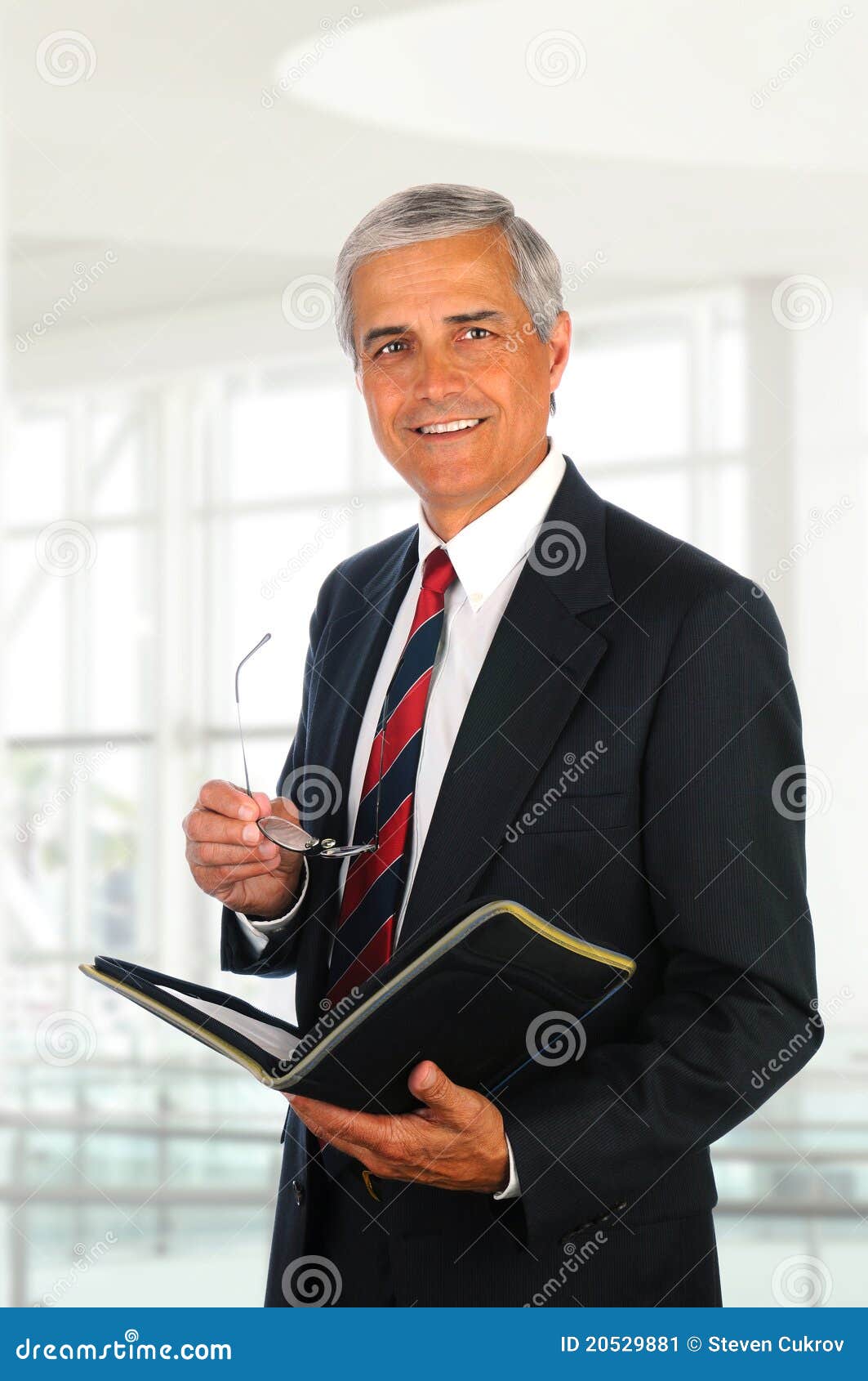 Businessman Holding Binder and Glasses Stock Image Image of friendly
