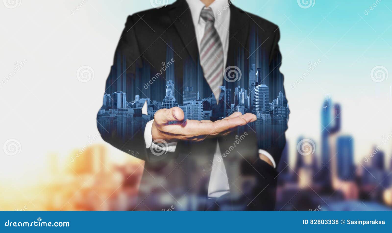 businessman holding blue modern buildings hologram on hand, with black and white city background