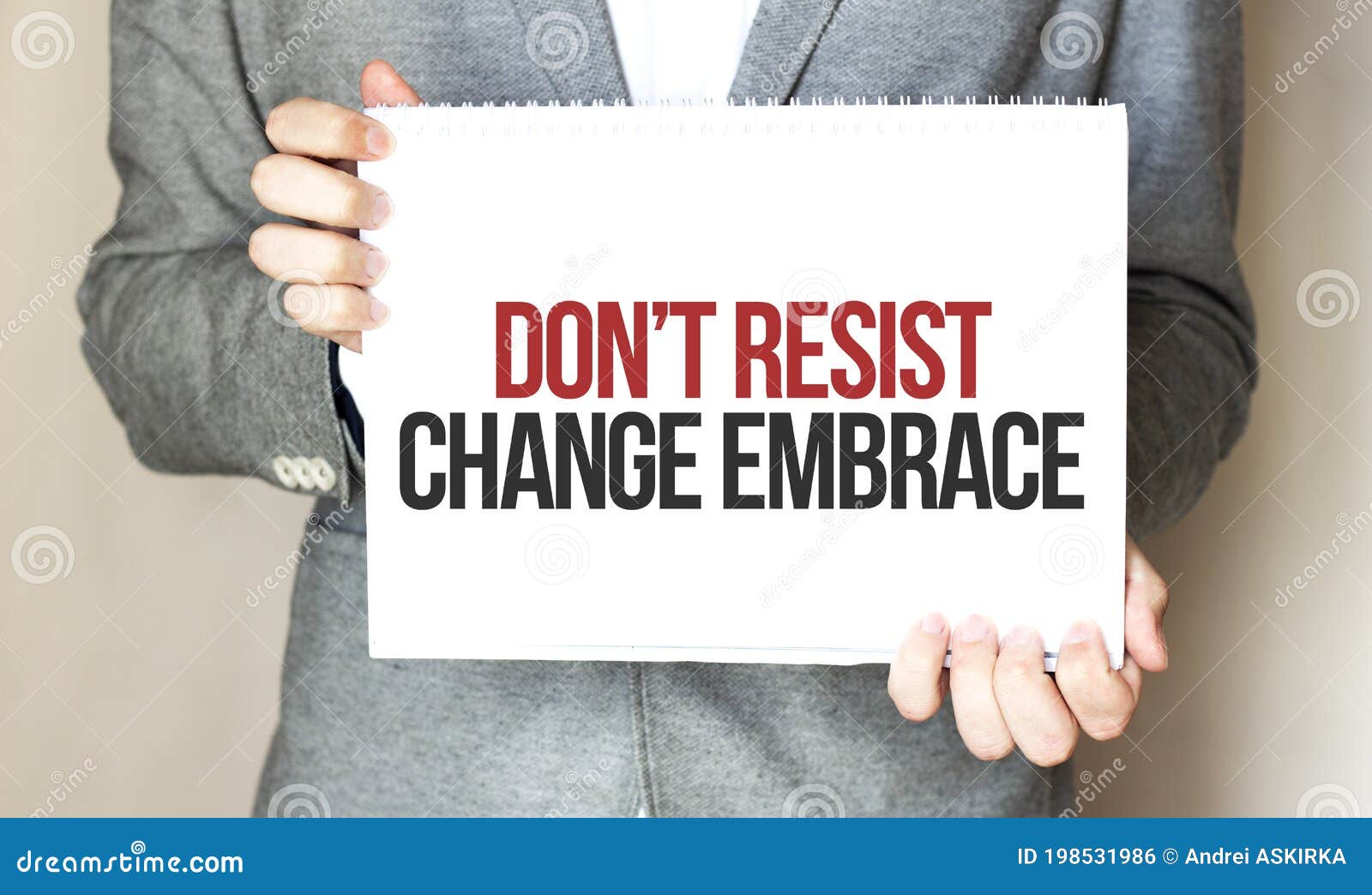 Businessman Holding a Card with Text Dont Resist Change Embrace Stock ...