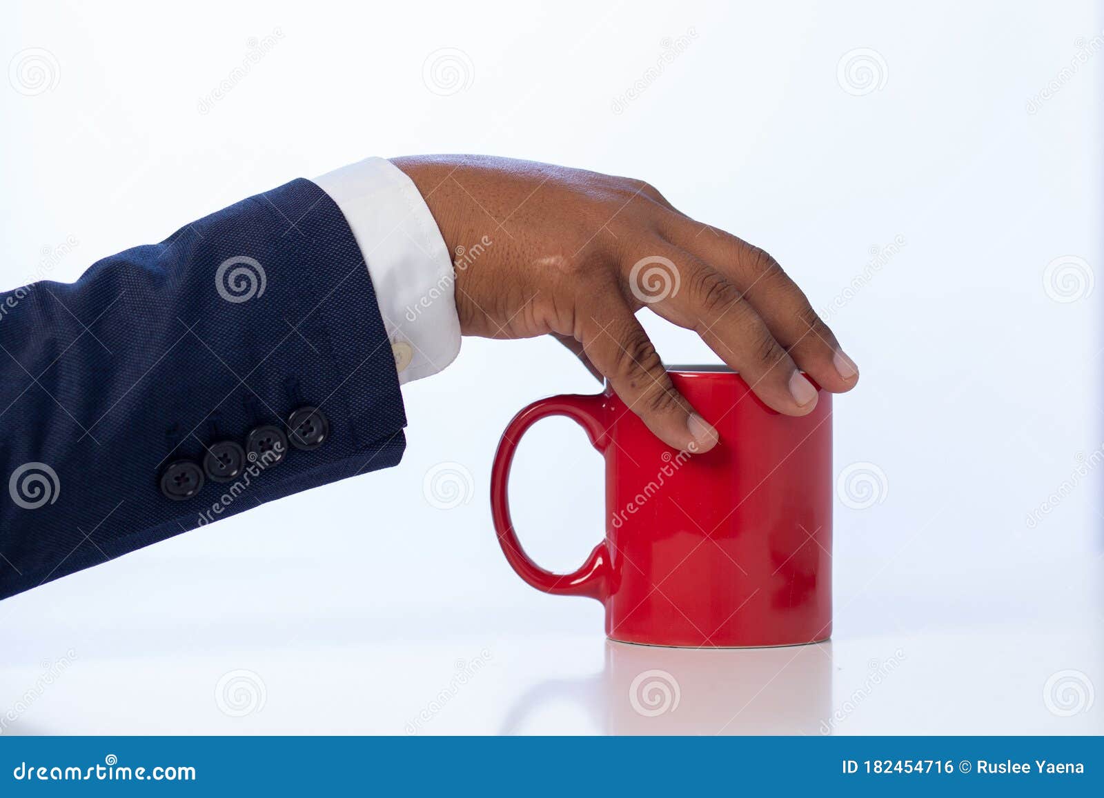 businessman holding a coffee cup on the white table at the office