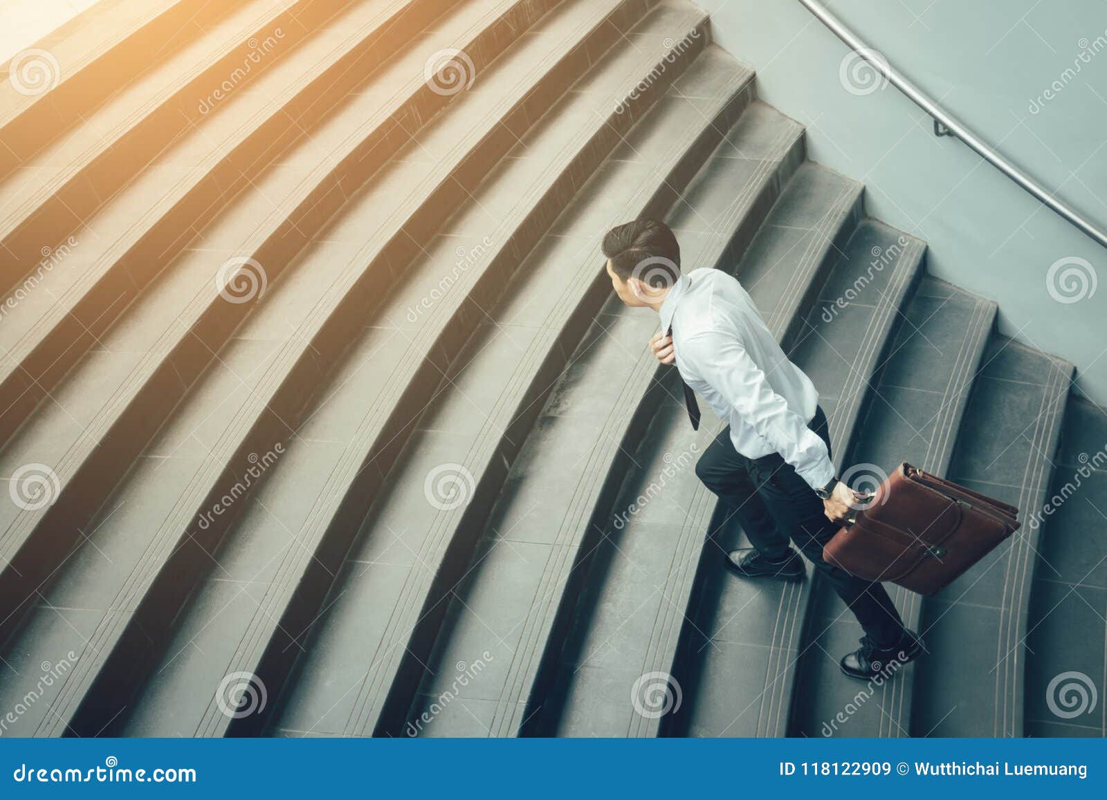 Businessman Holding Suitcase and Running on Stairs. Stock Image - Image