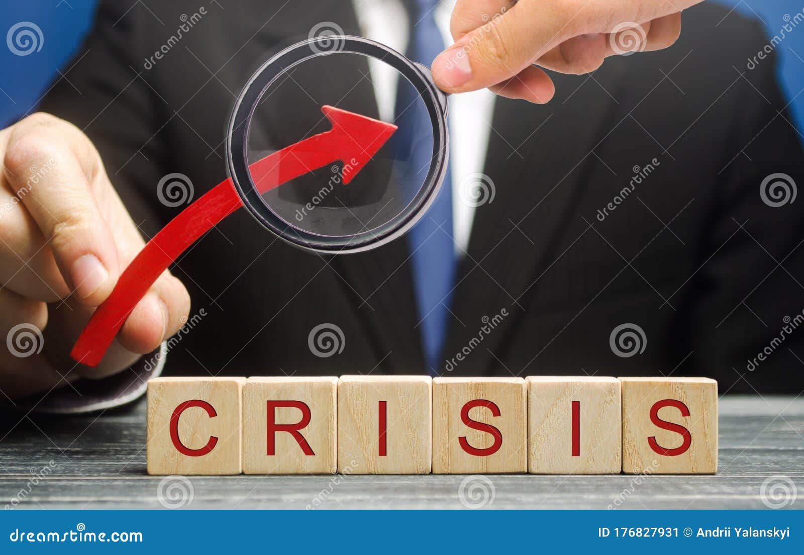 businessman holds up arrow over blocks with the word crisis. increase instability of business and economy. recession, stagnation,