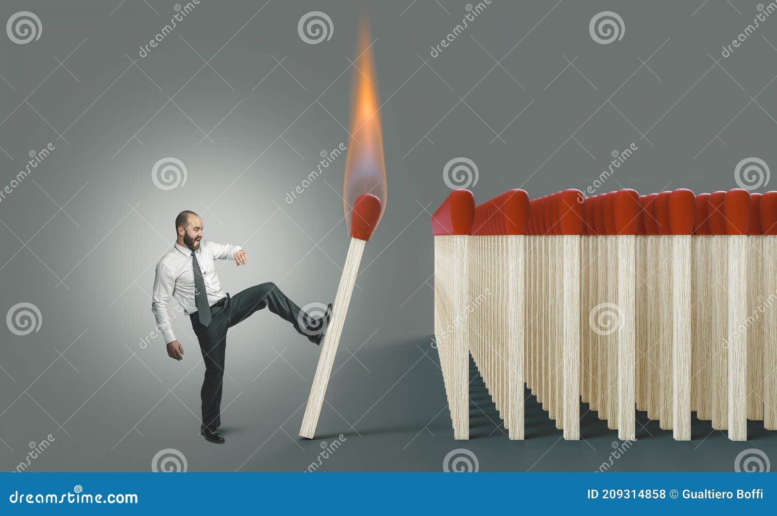 businessman kicking a lit match to ignite a chain reaction