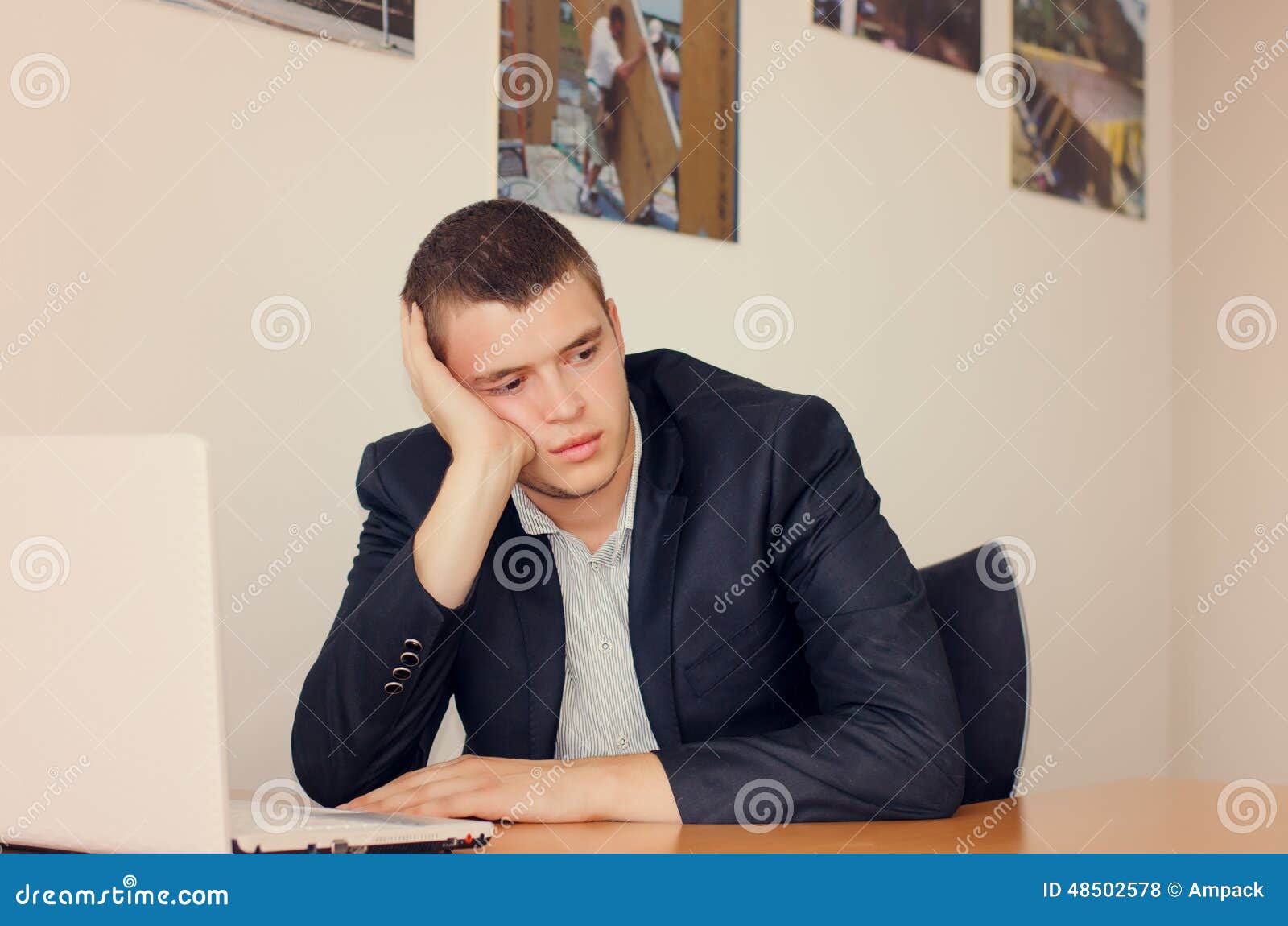 businessman-laptop-resting-head-hand-young-office-looking-bored-48502578.jpg
