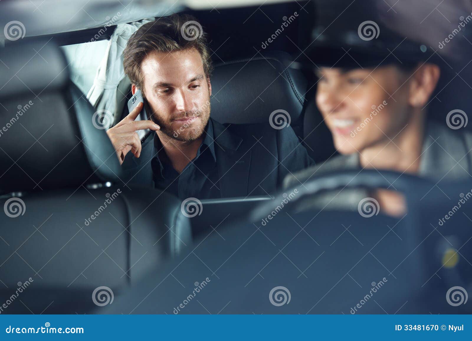 businessman in limousine chauffeur driving