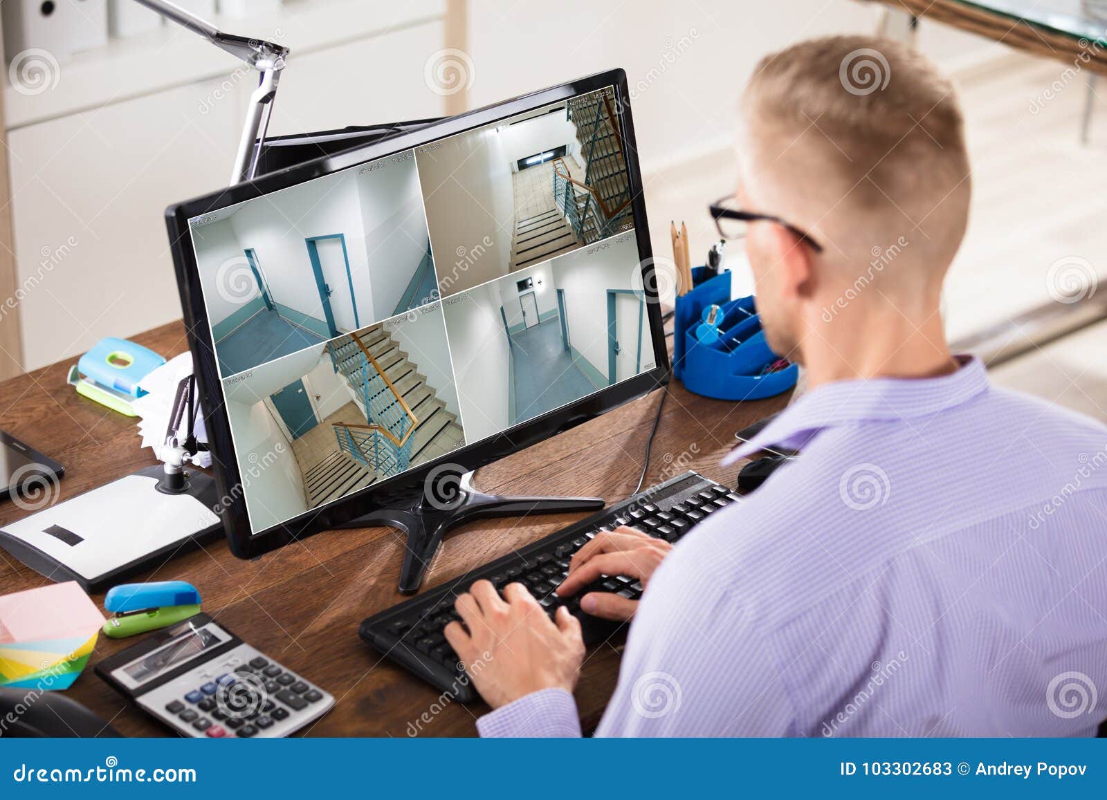 businessman looking at cctv footage on computer