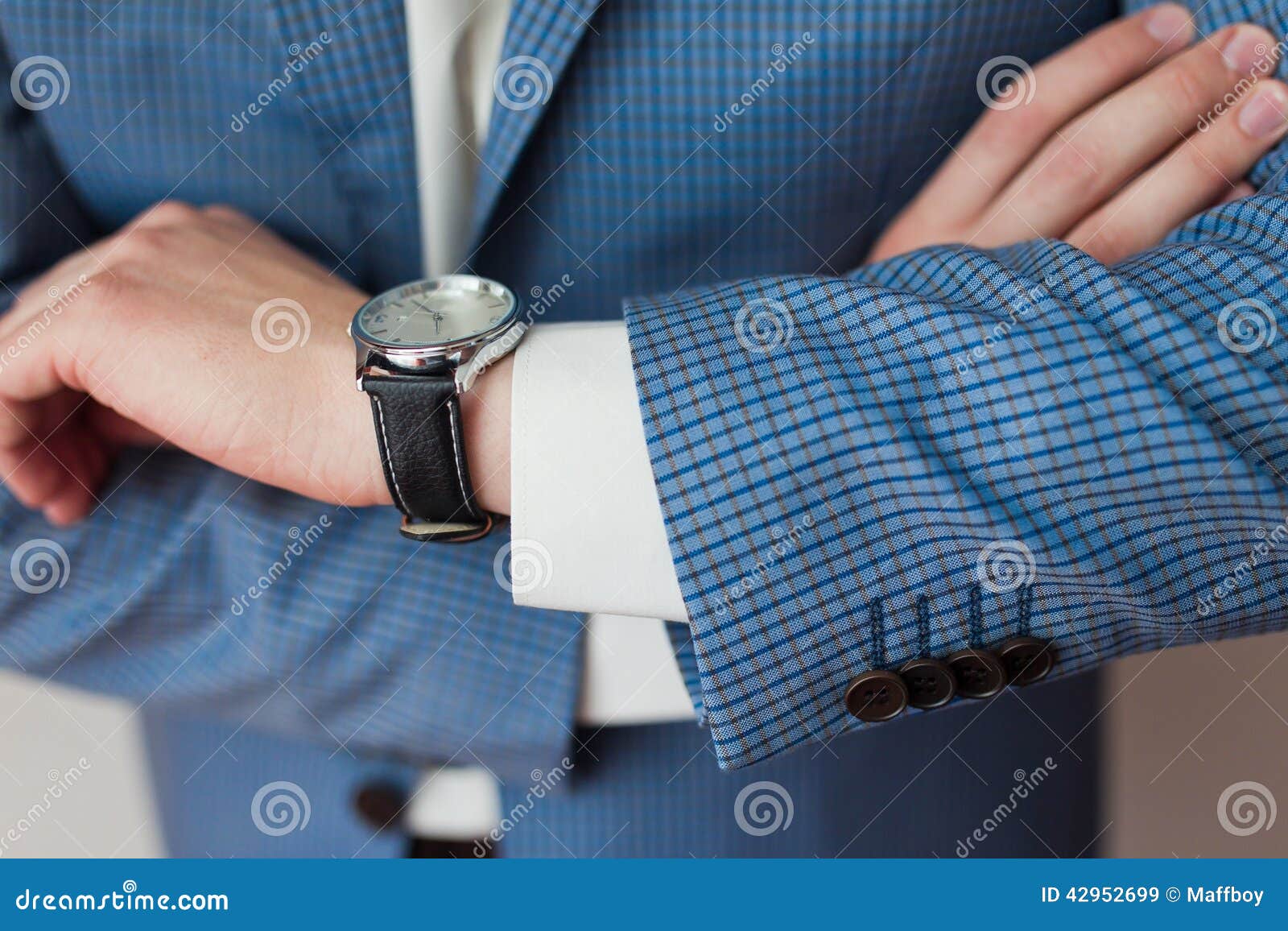 businessman looks the time on his wristwatch