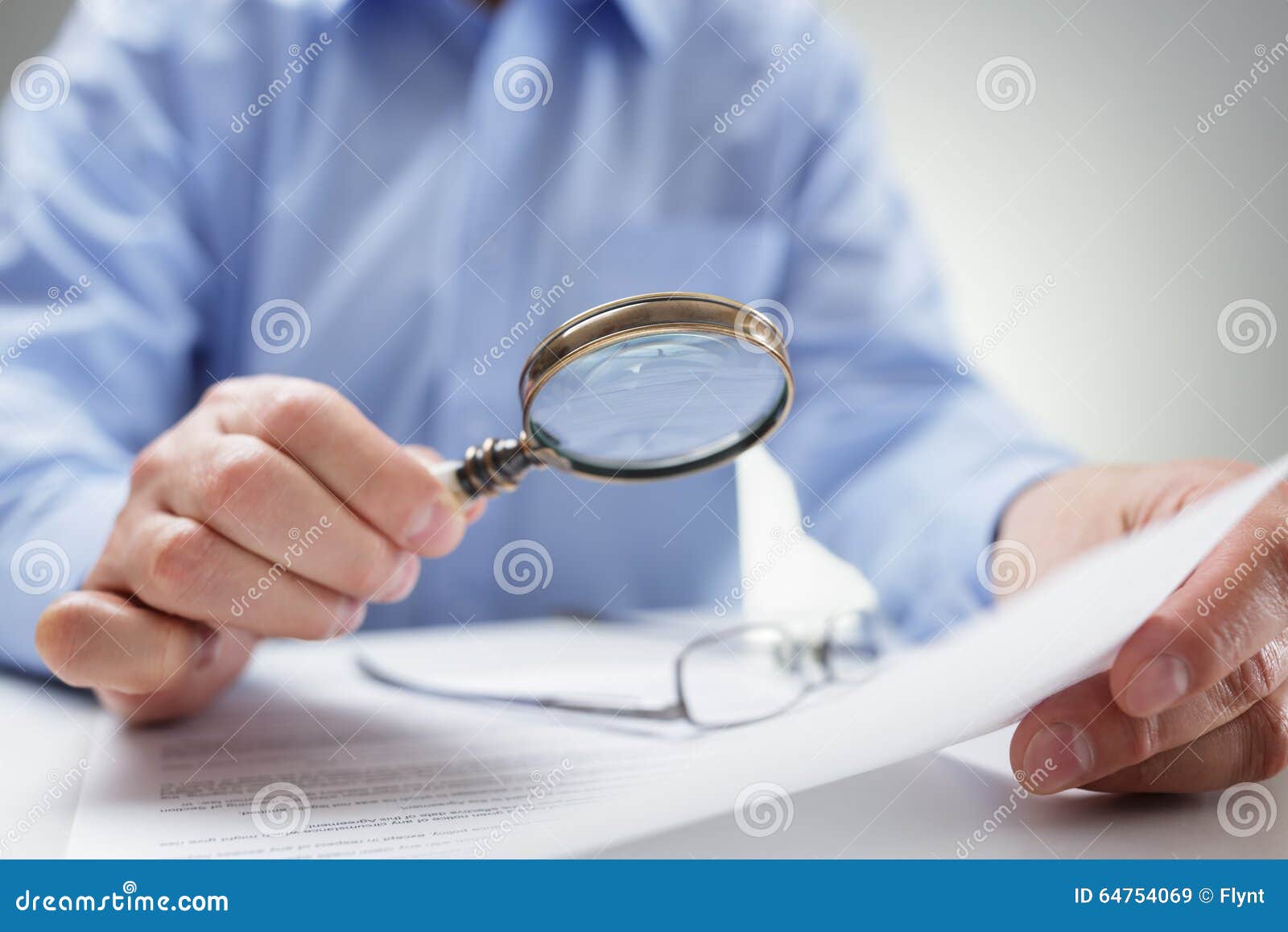 businessman with magnifying glass reading documents