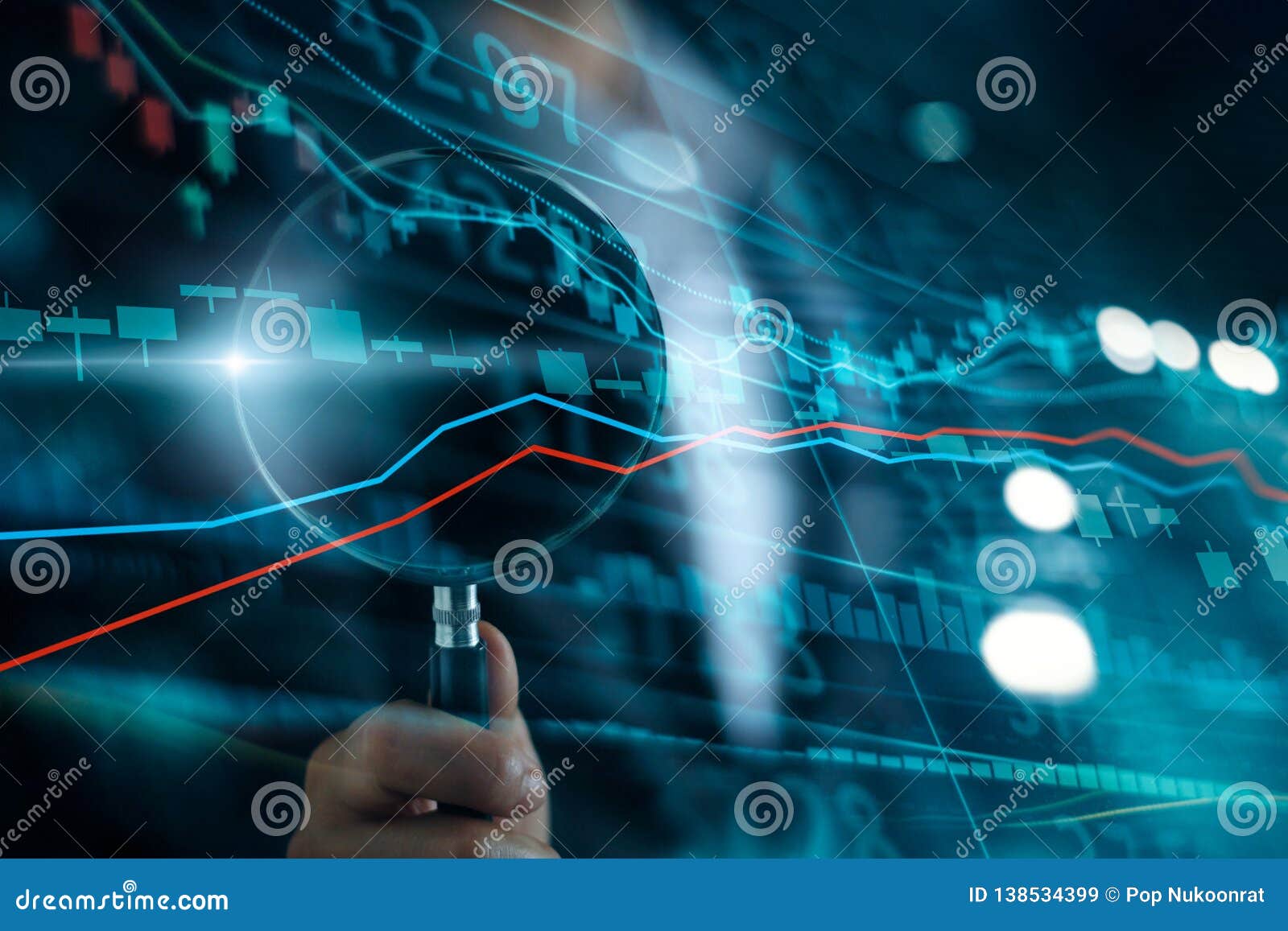 businessman with magnifying glass search of investing and stock market. gain and profits with candlestick charts.