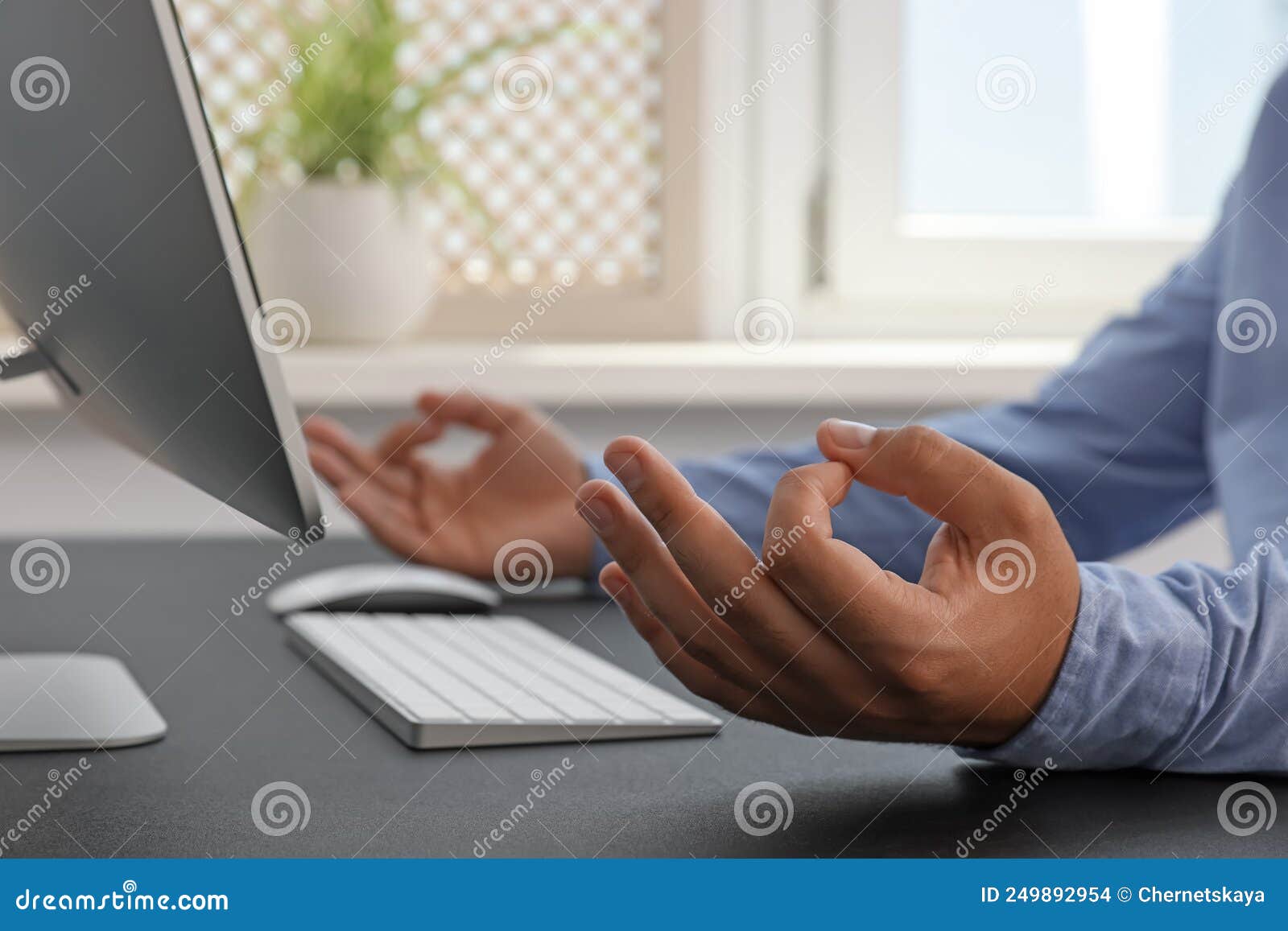 Businessman Meditating at Workplace, Closeup. Zen Concept Stock Photo