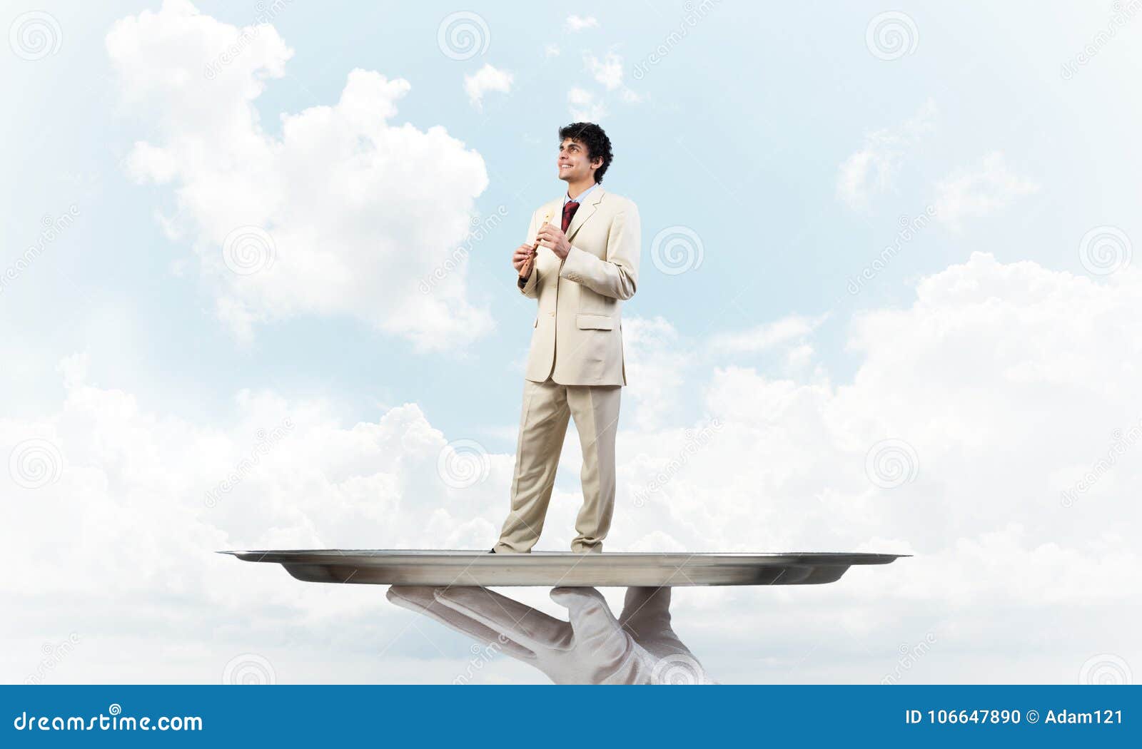 Businessman On Metal Tray Playing Fife Against Blue Sky Background