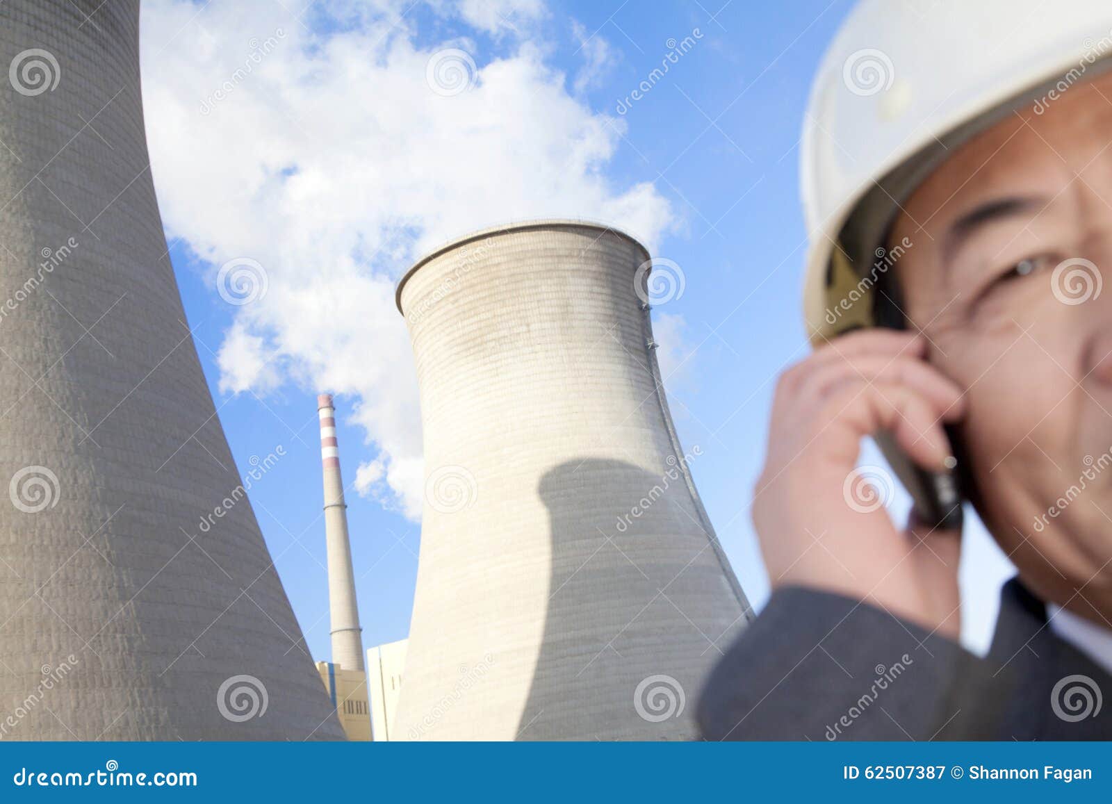 businessman on mobile phone at power plant