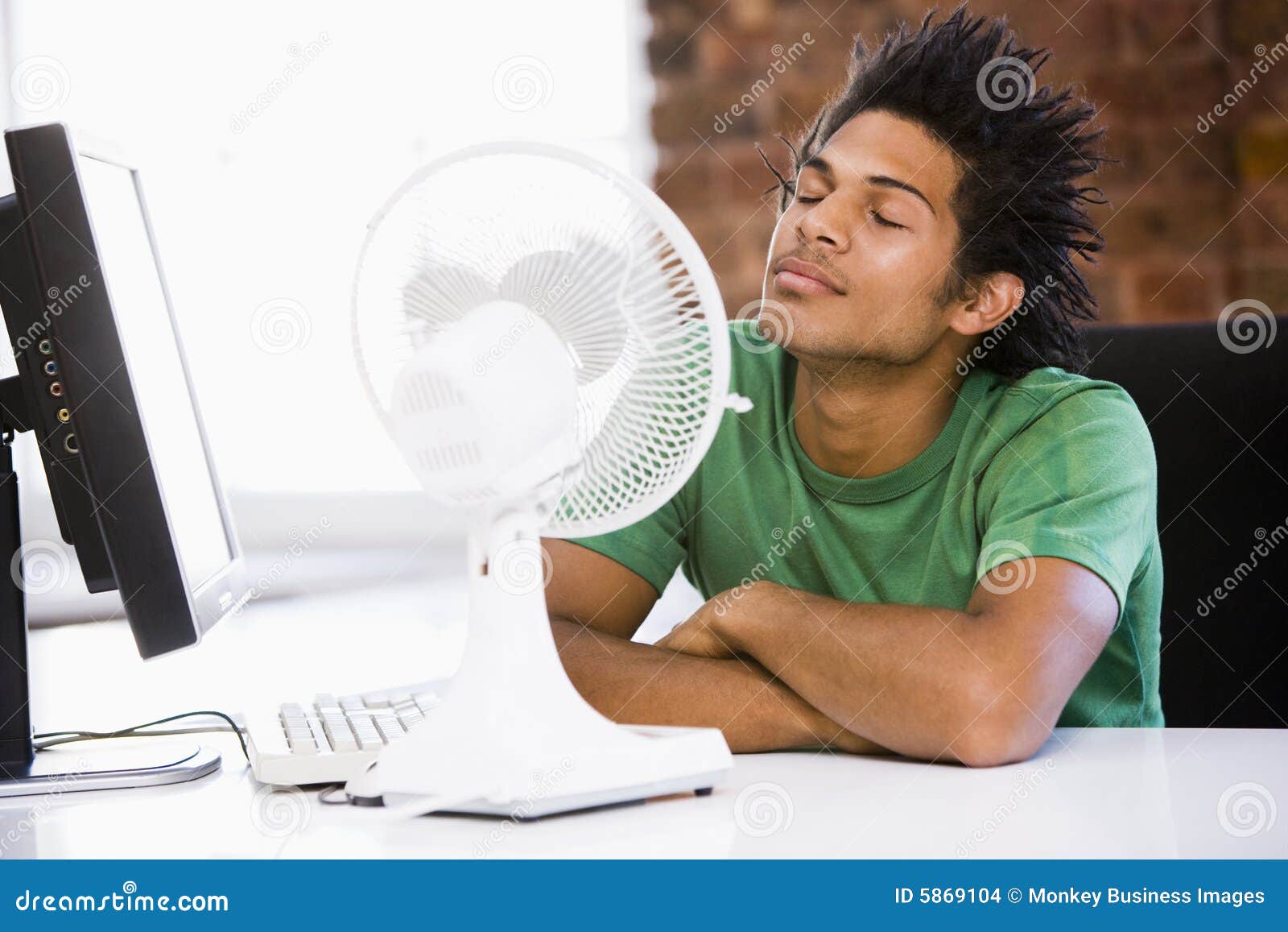 businessman in office with computer and fan