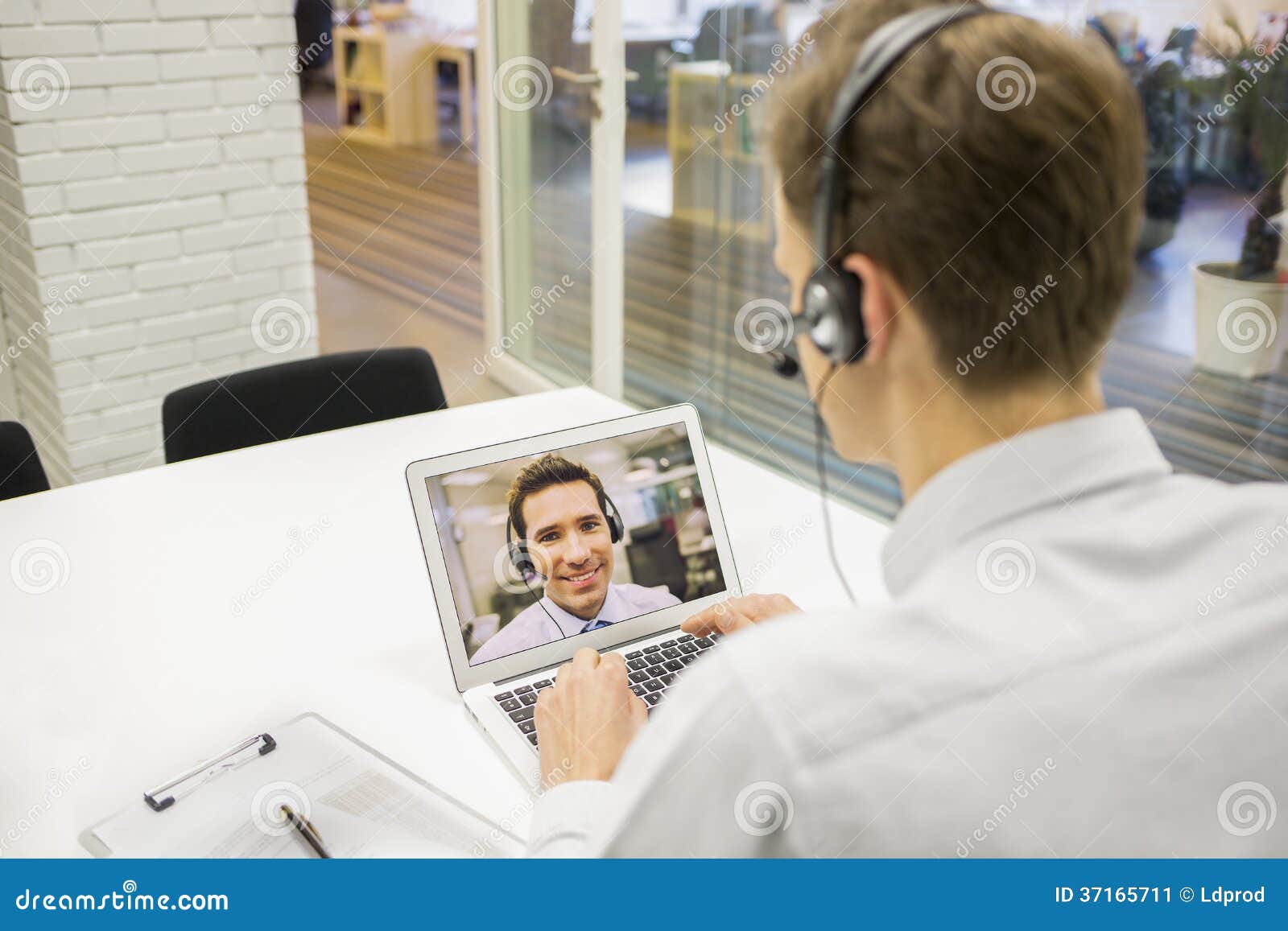 businessman in the office on videoconference with headset, skype