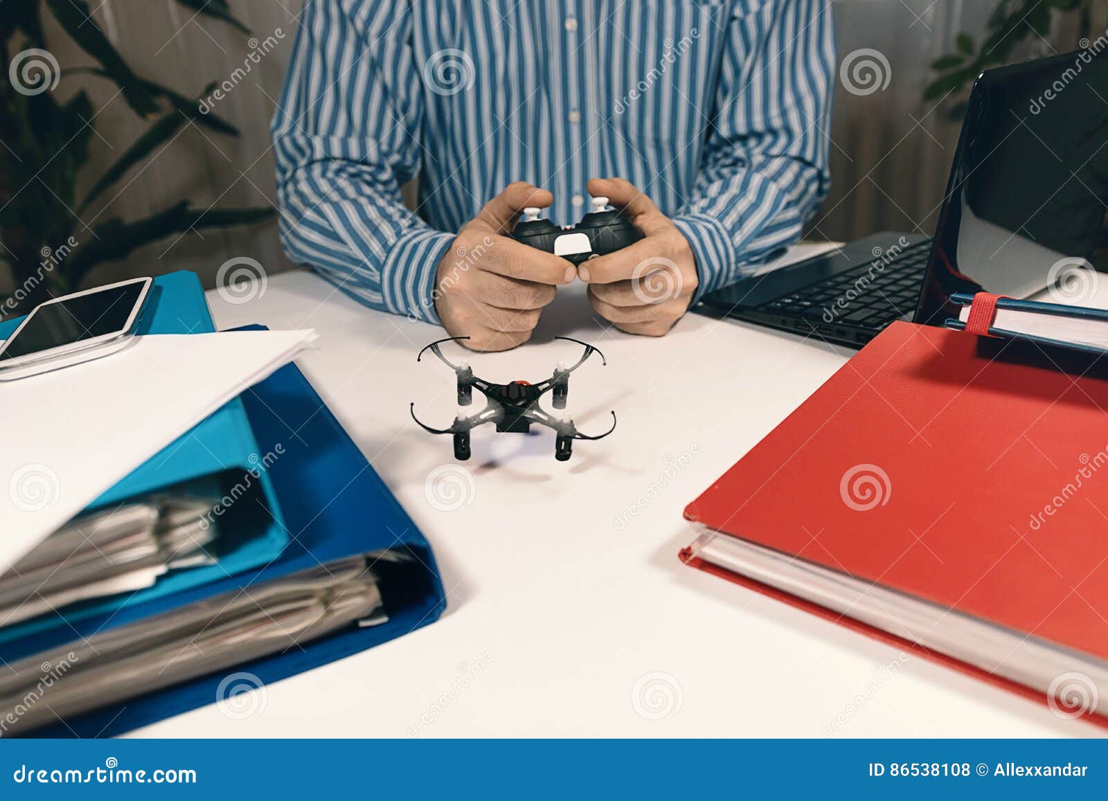 Businessman Playing With Drone Toy To Relieve Stress At Work