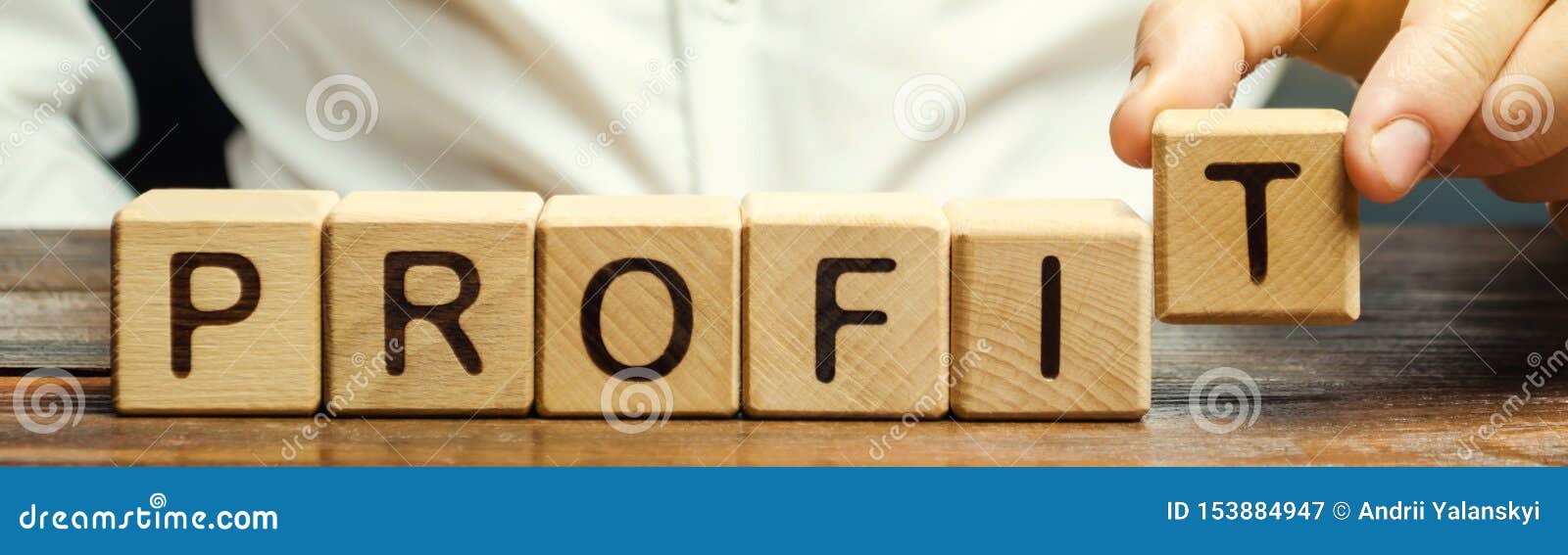 businessman puts wooden blocks with the word profit. the financial result of the company for a certain period of time. income.