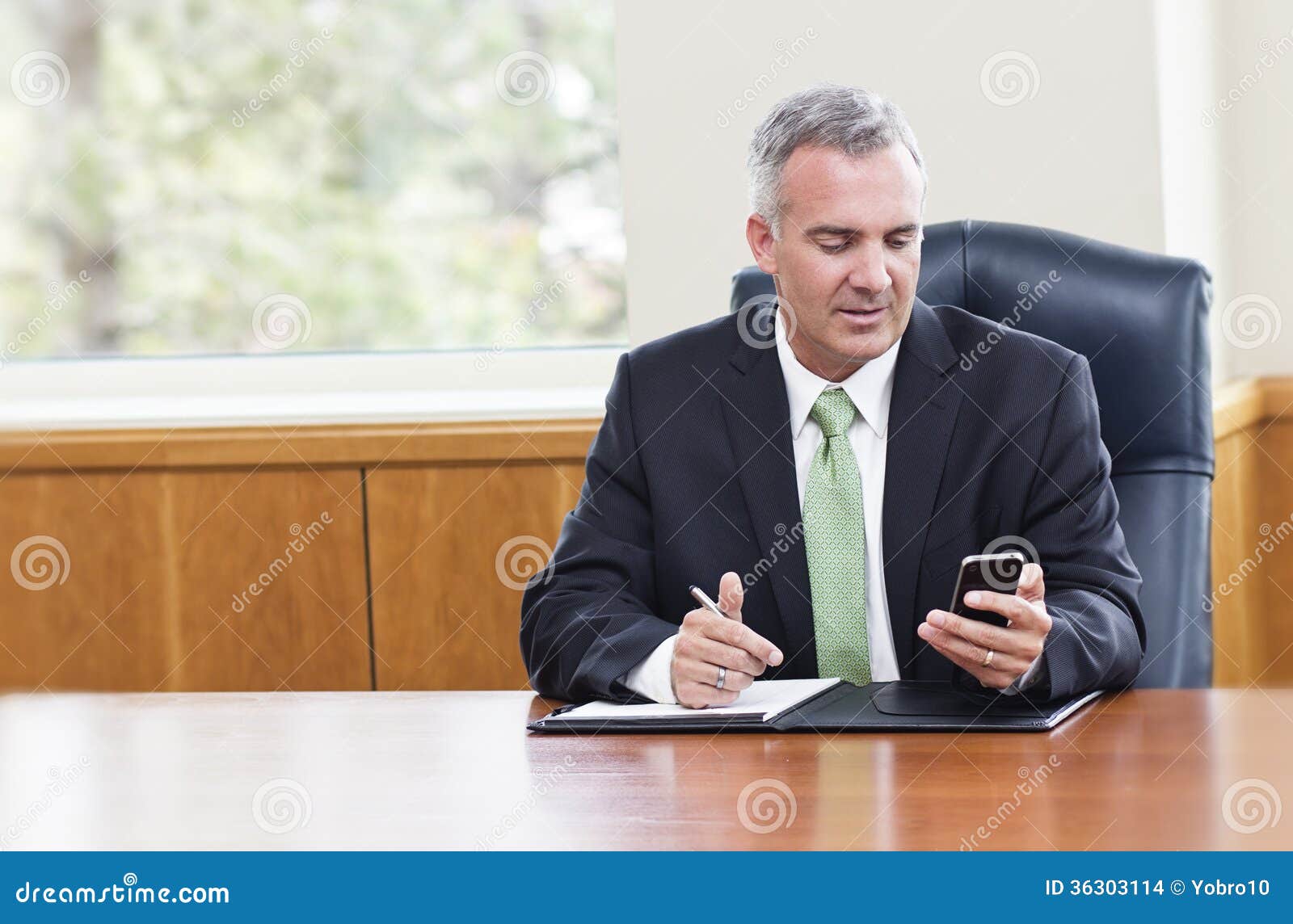 businessman reading text messages on his phone