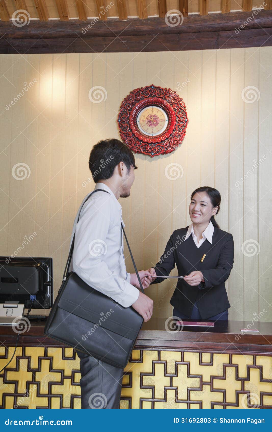 businessman at reception desk of hotel