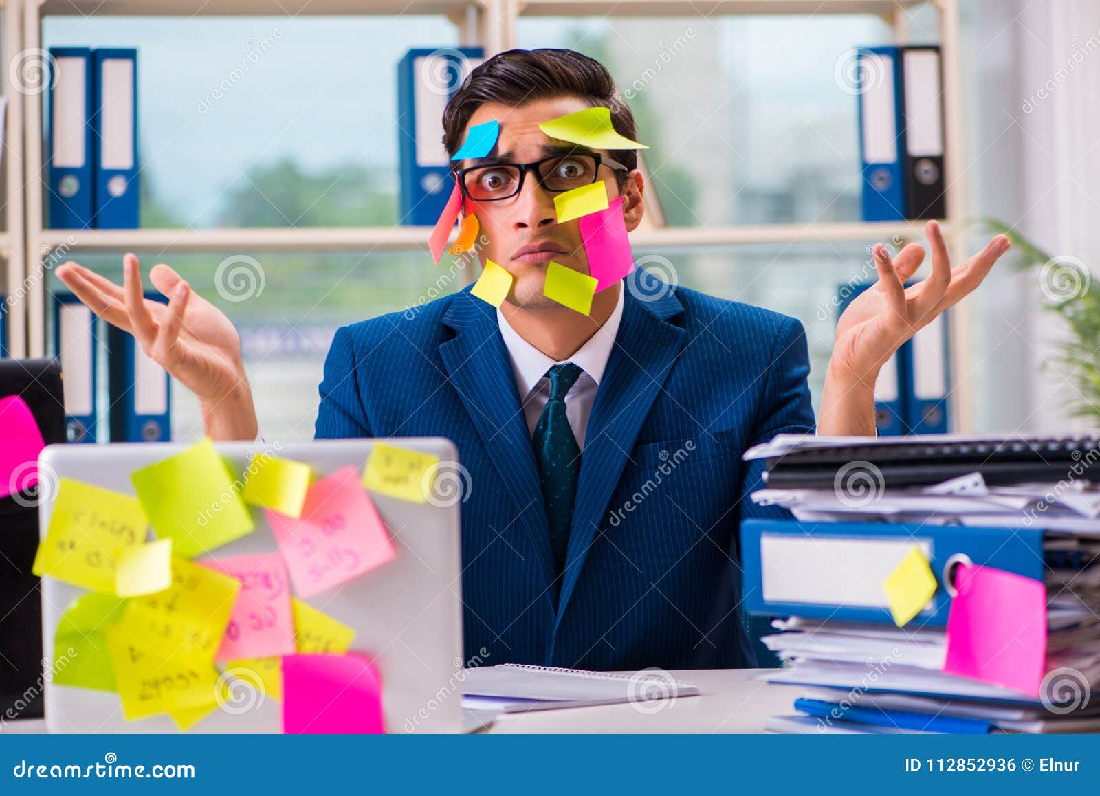 the businessman with reminder notes in multitasking concept